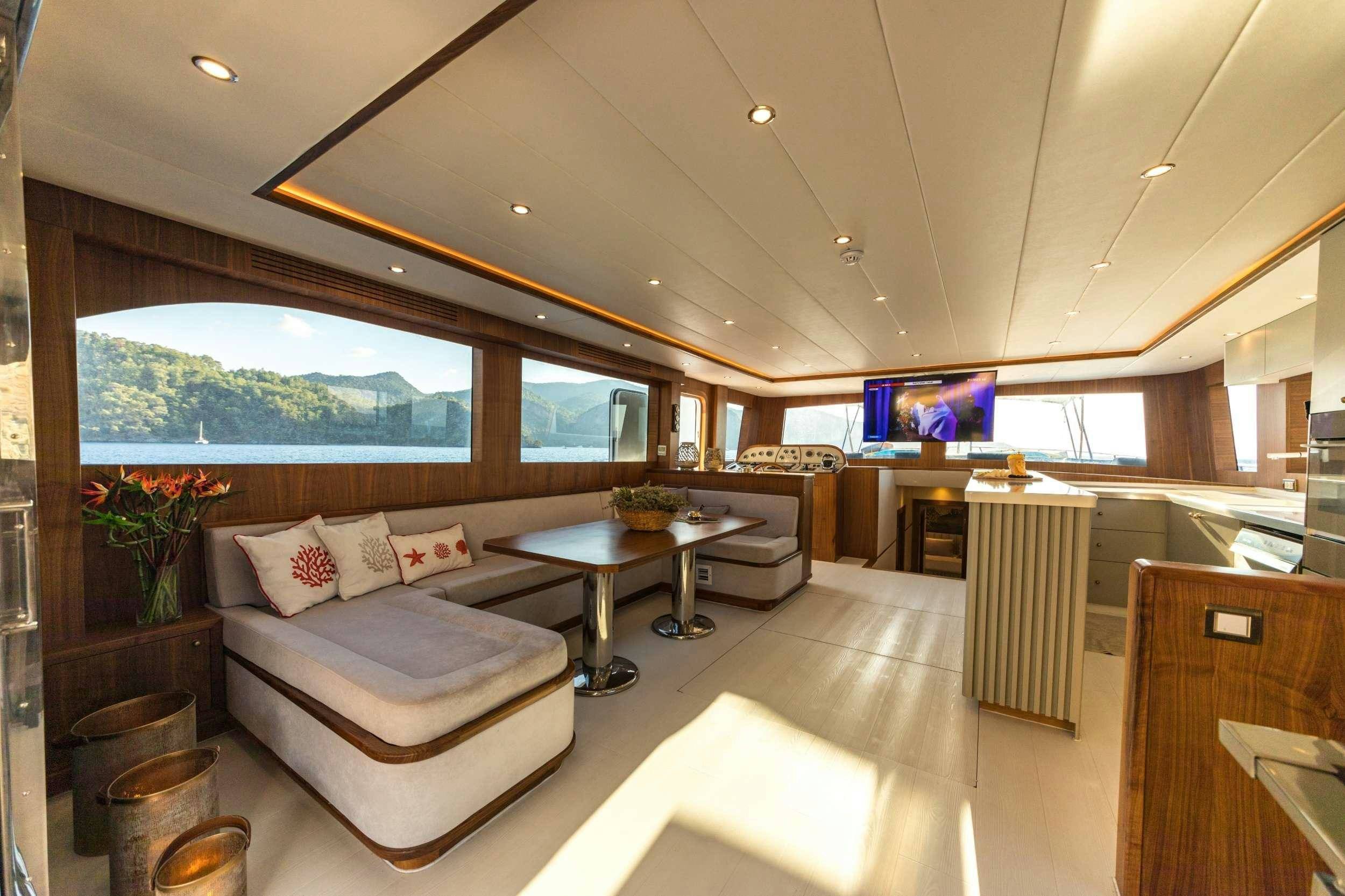 a living room with a large window aboard FLOKI Yacht for Charter