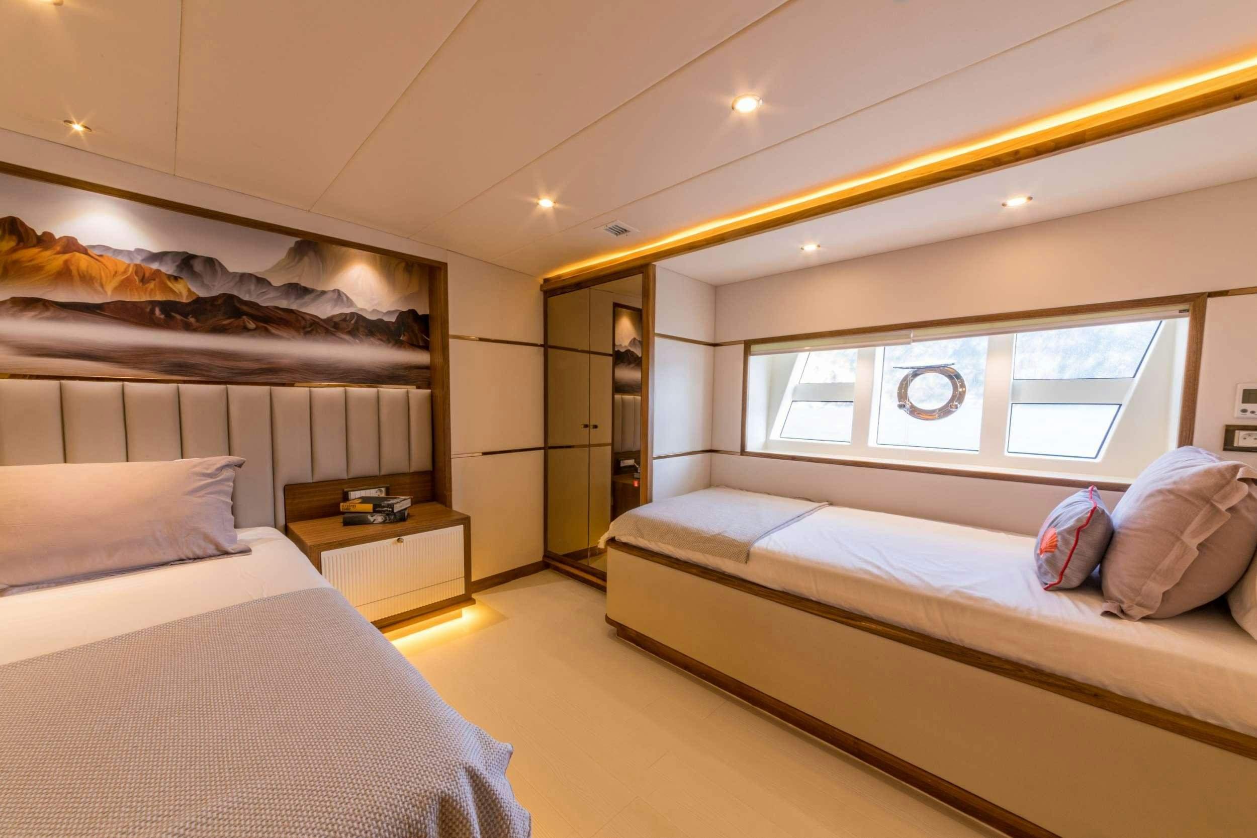a room with two beds aboard FLOKI Yacht for Charter
