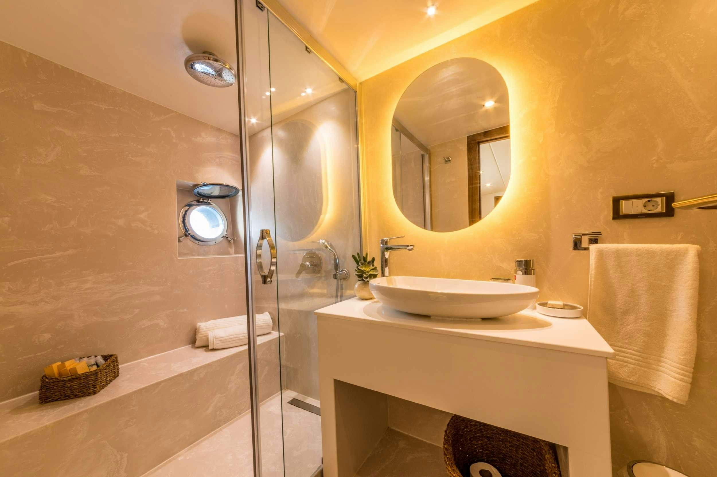 a bathroom with a glass shower aboard FLOKI Yacht for Charter
