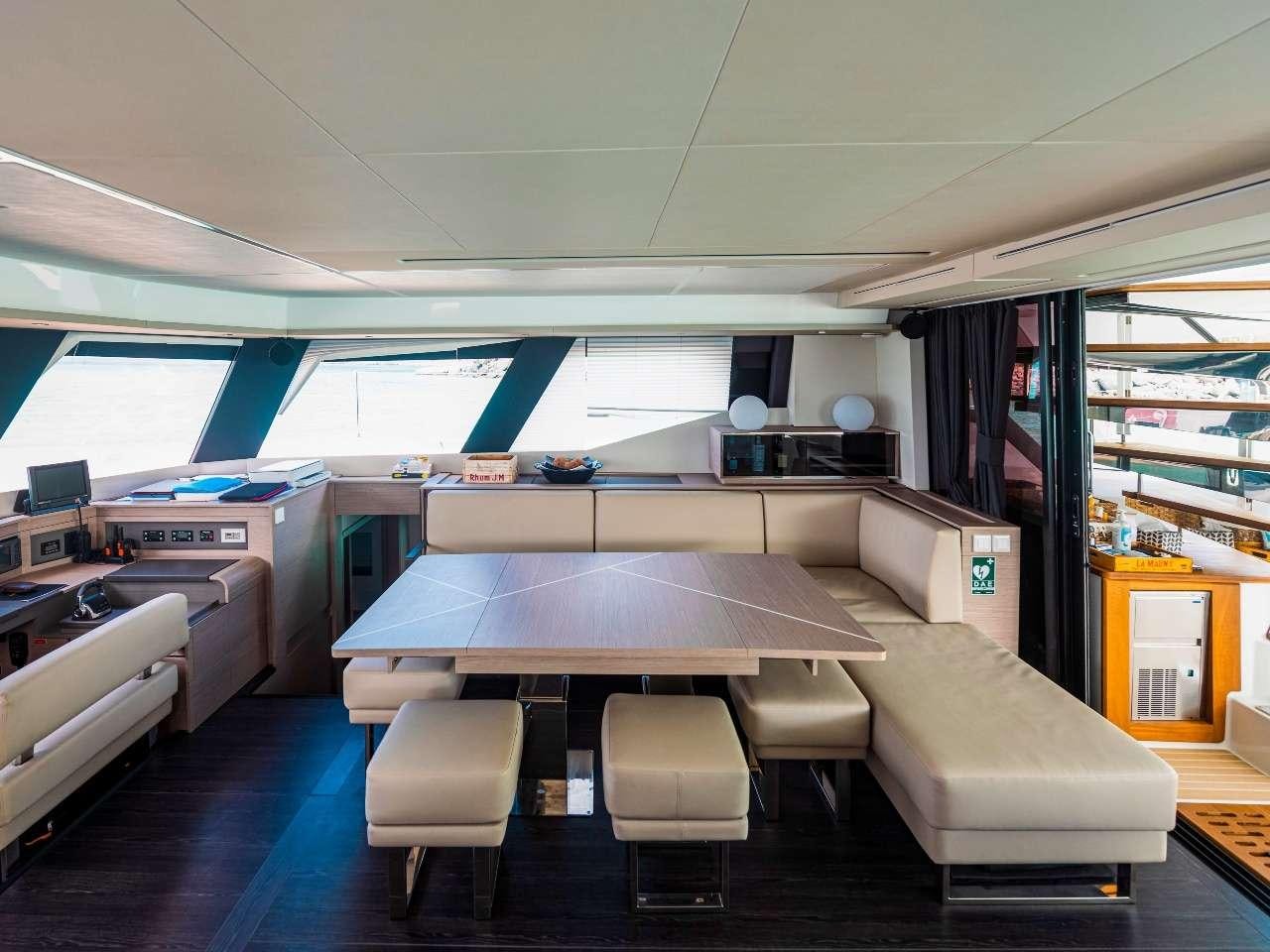 a room with a table and chairs aboard ADEONA Yacht for Charter