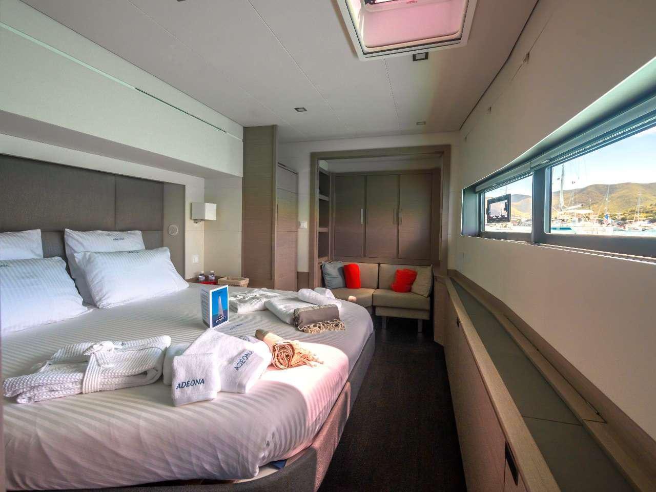 a room with a bed and a couch aboard ADEONA Yacht for Charter