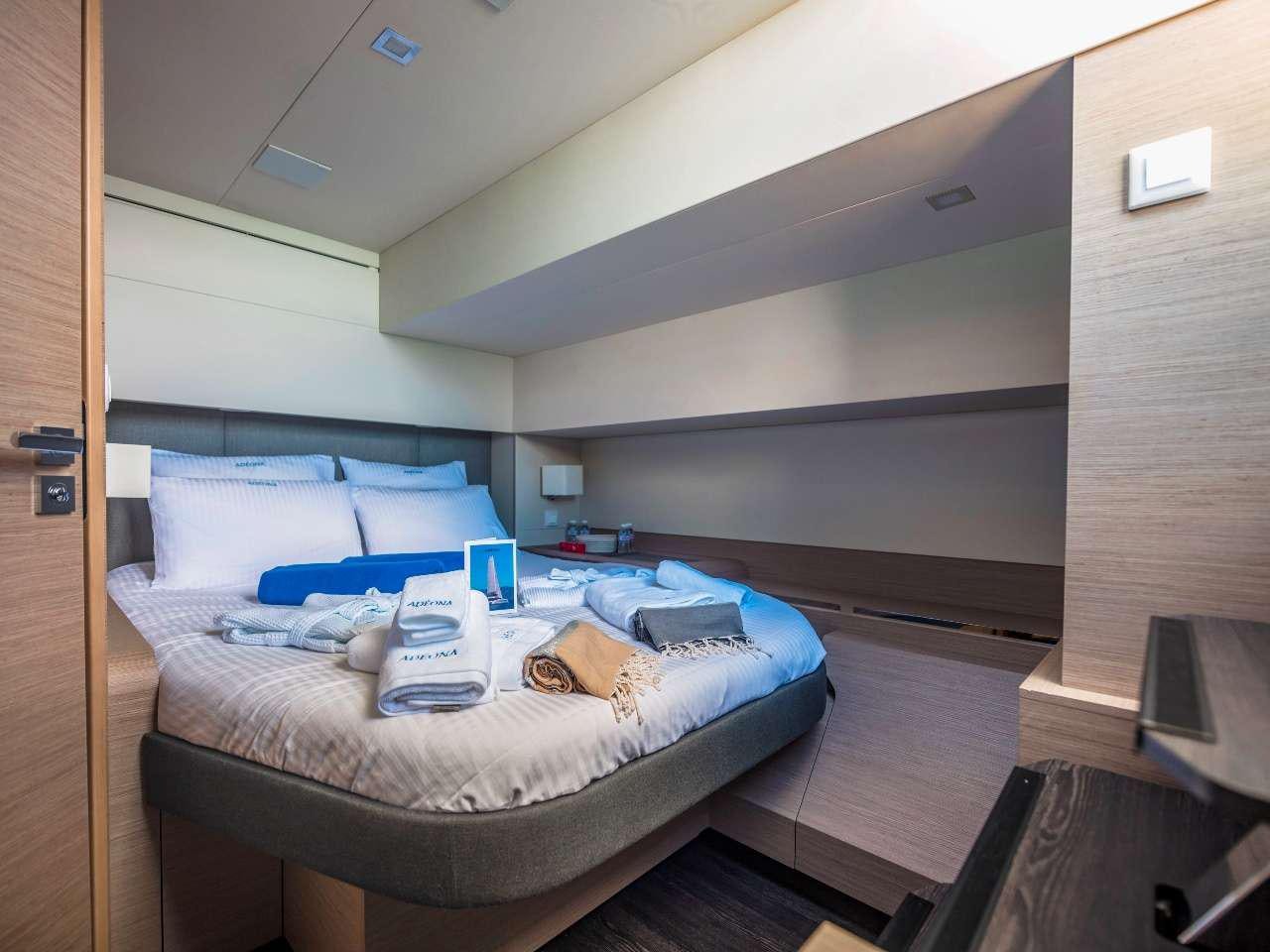 a room with a bed and a desk aboard ADEONA Yacht for Charter