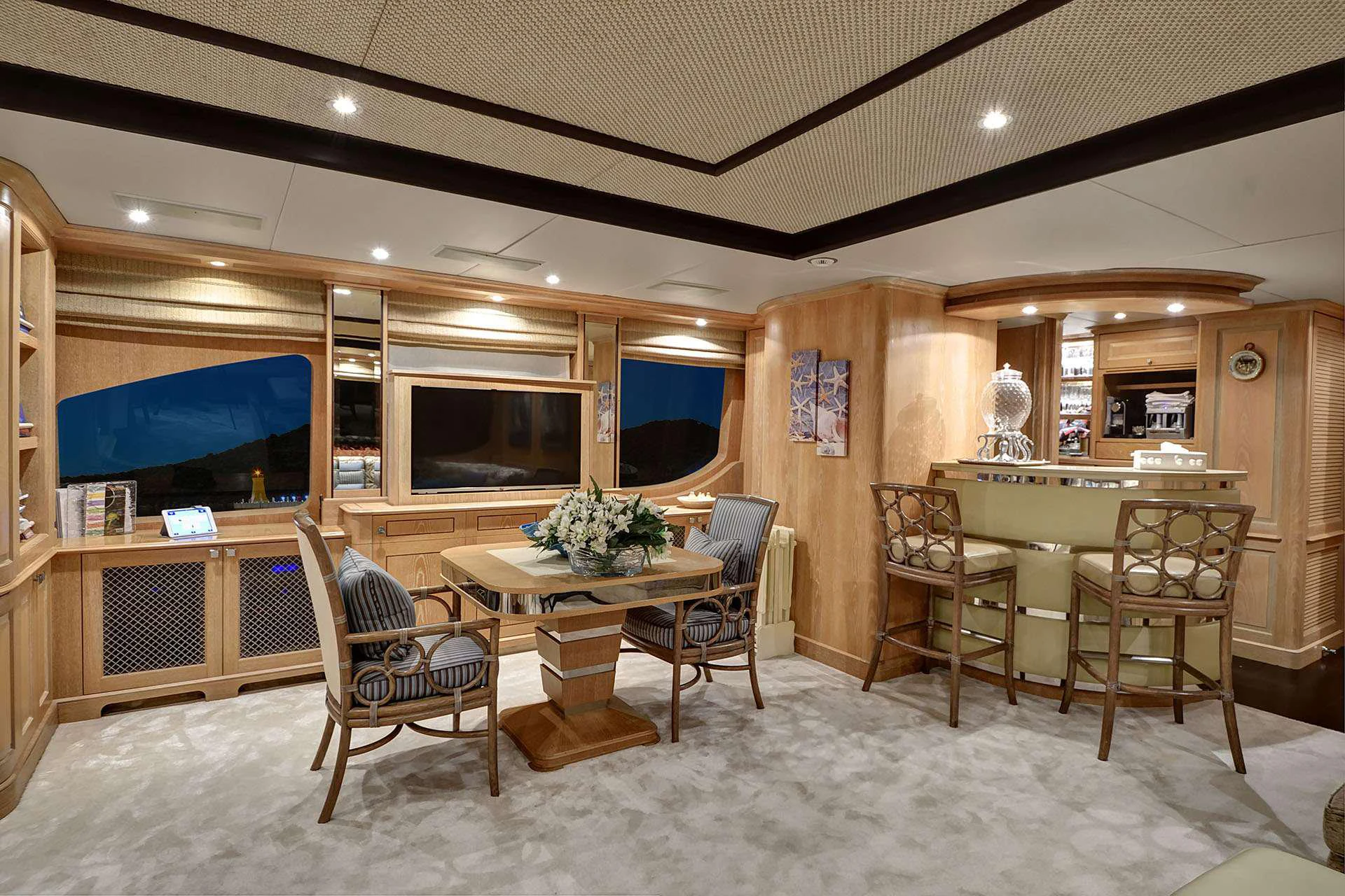 a room with chairs and a table aboard QUEST R Yacht for Charter