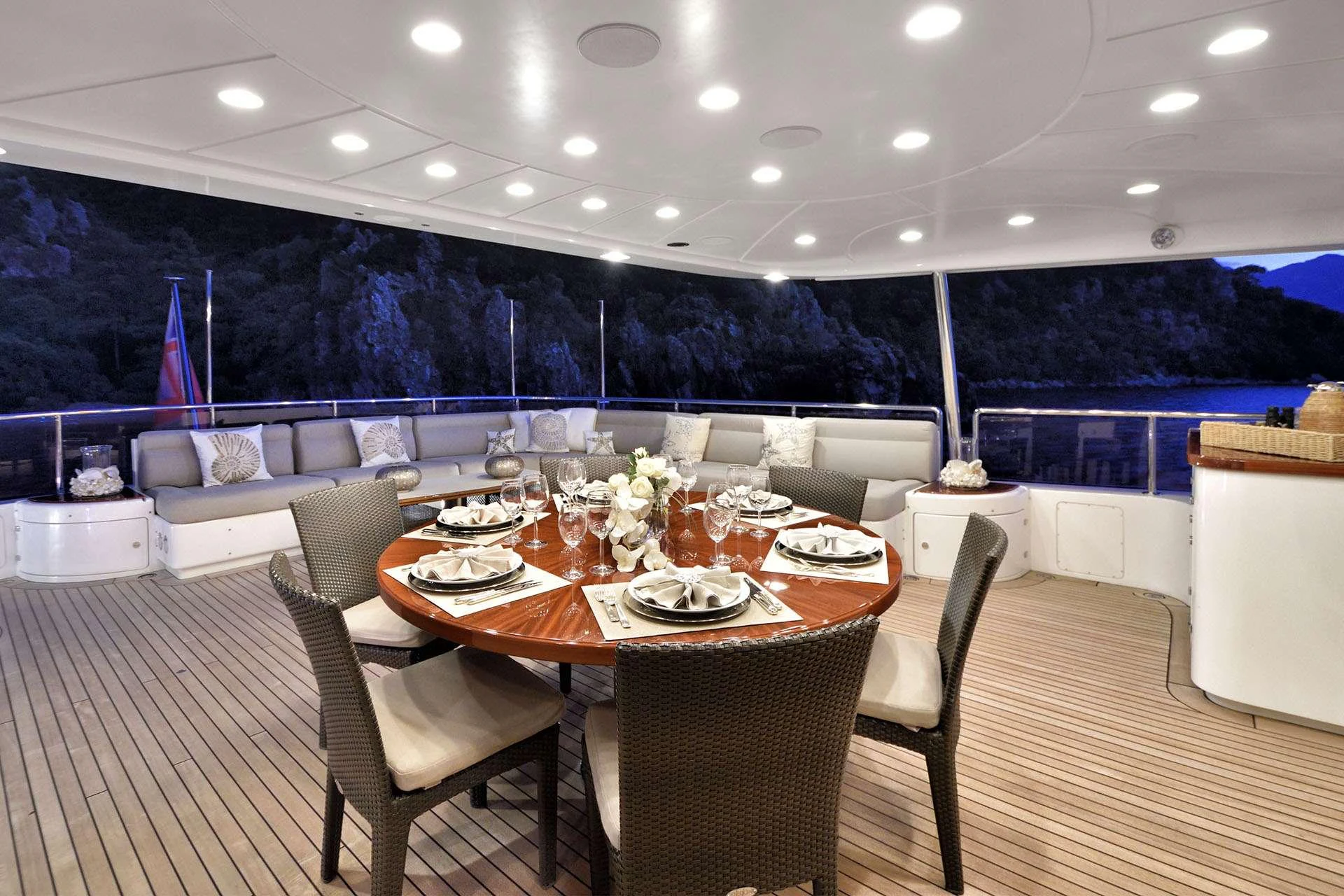 a table set for a dinner party aboard QUEST R Yacht for Charter