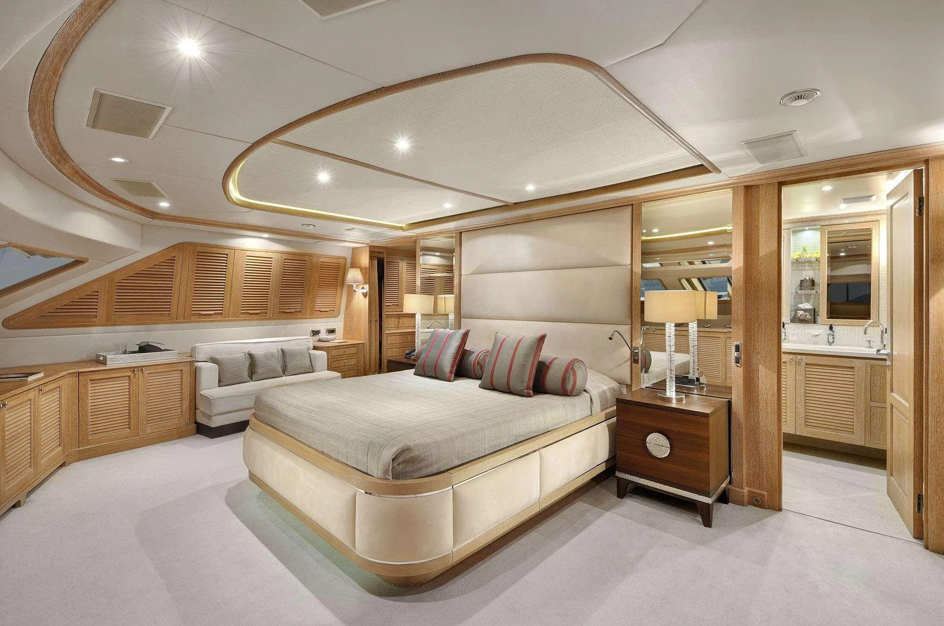 a large room with a bed and a large mirror aboard QUEST R Yacht for Charter