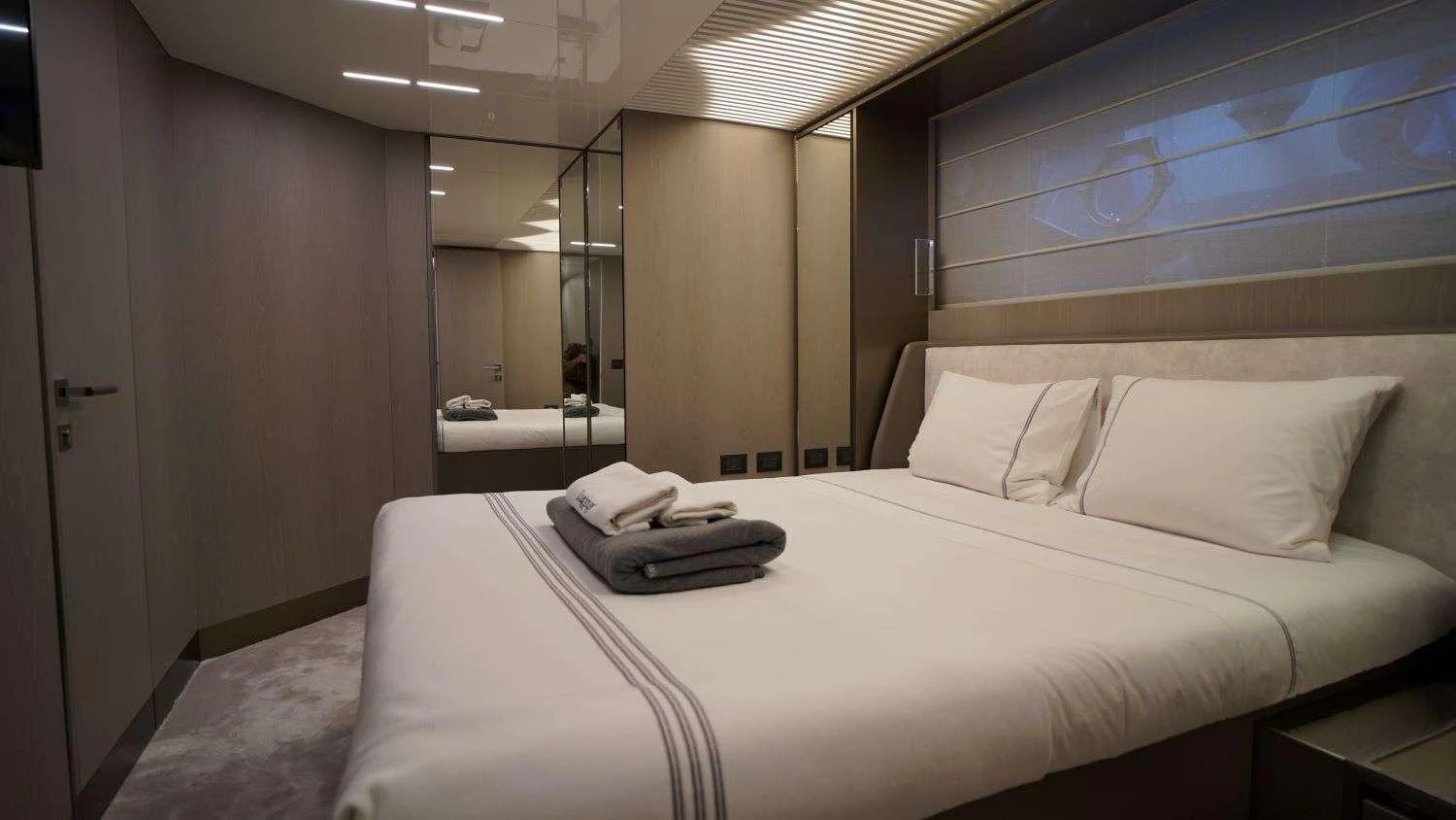 a bed with white sheets aboard SHERO Yacht for Charter