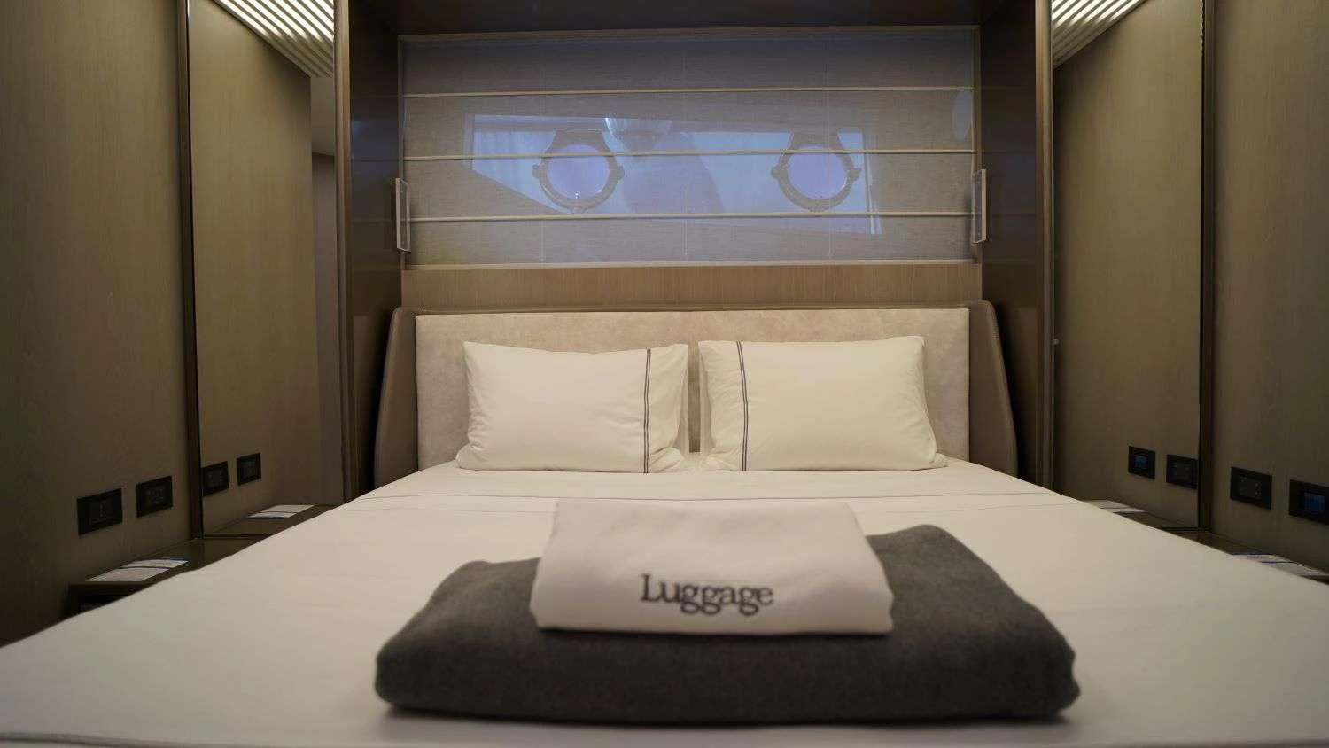 a bed with white sheets and pillows aboard SHERO Yacht for Charter