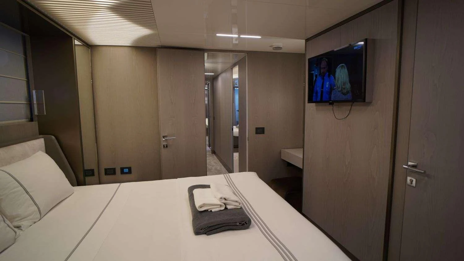 a room with a tv and a bed aboard SHERO Yacht for Charter