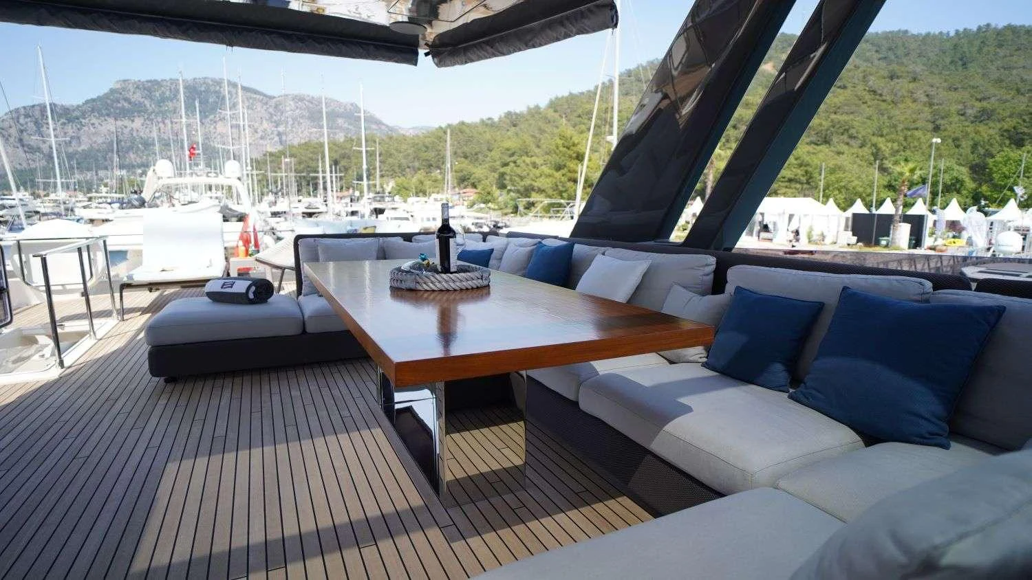 a deck with a table and chairs aboard SHERO Yacht for Charter