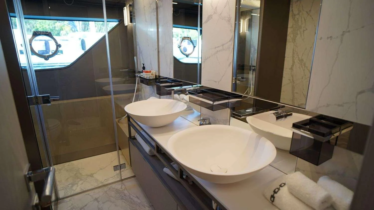 a bathroom with a sink and a large mirror aboard SHERO Yacht for Charter