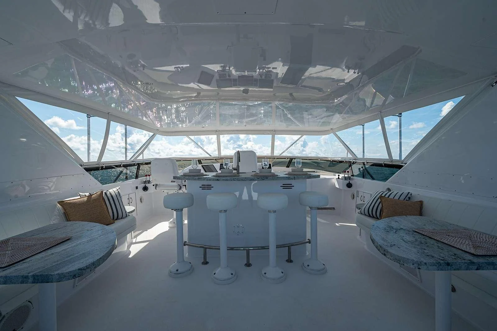 a room with white tables and chairs aboard MAGNUM RIDE Yacht for Charter