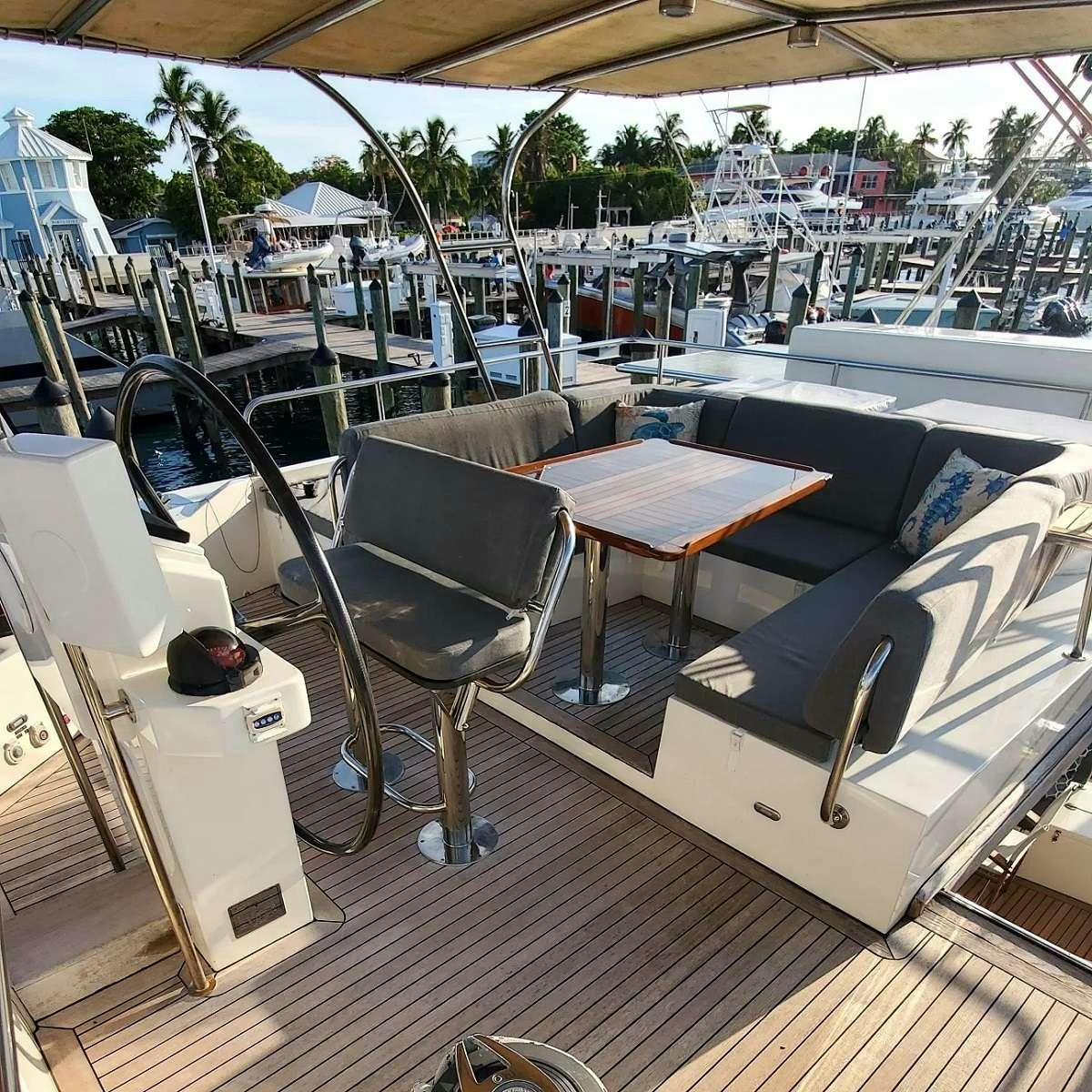 a deck with tables and chairs aboard SERENDIPITY Yacht for Charter