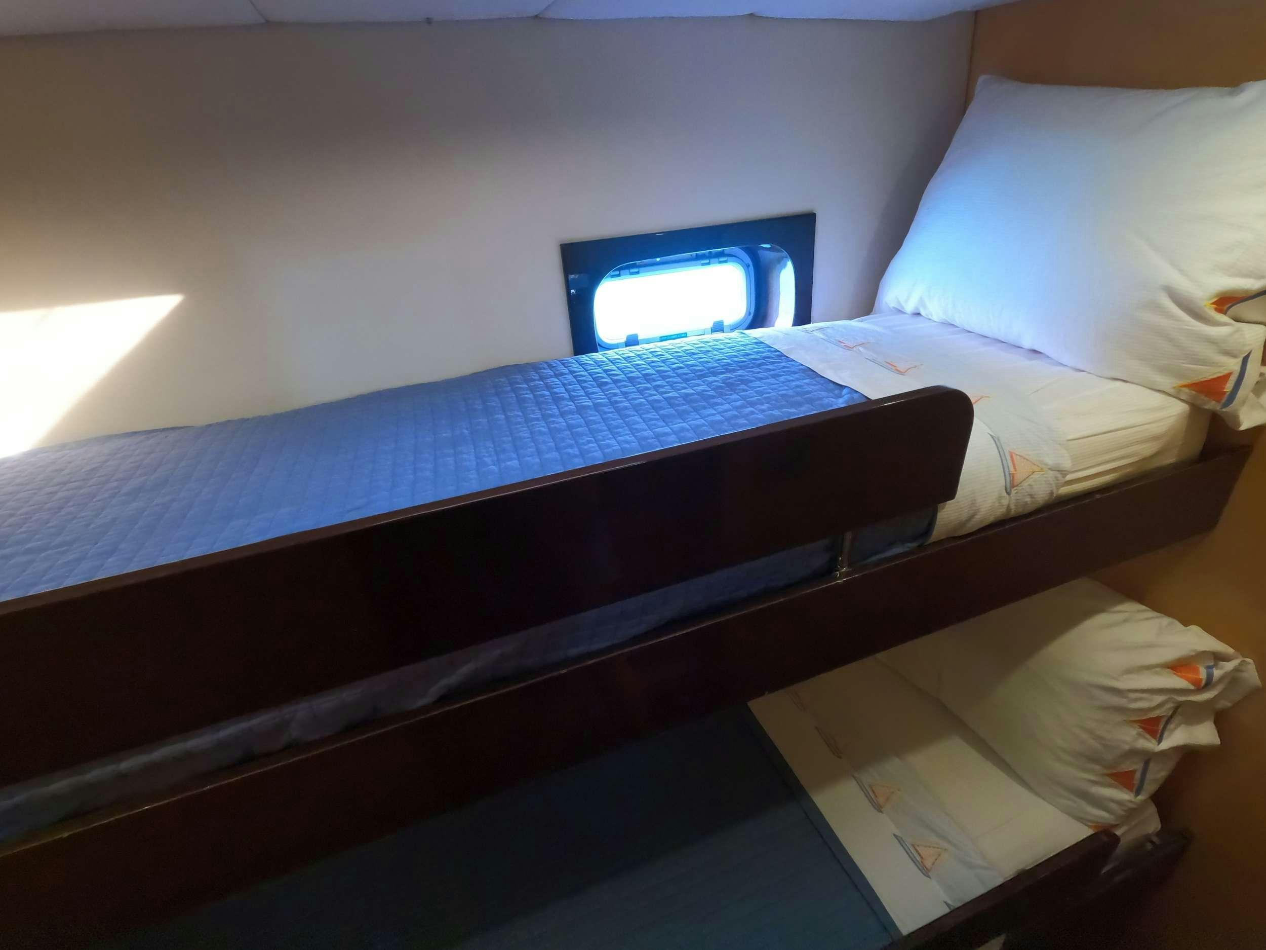 a bed with a television on top aboard SERENDIPITY Yacht for Charter