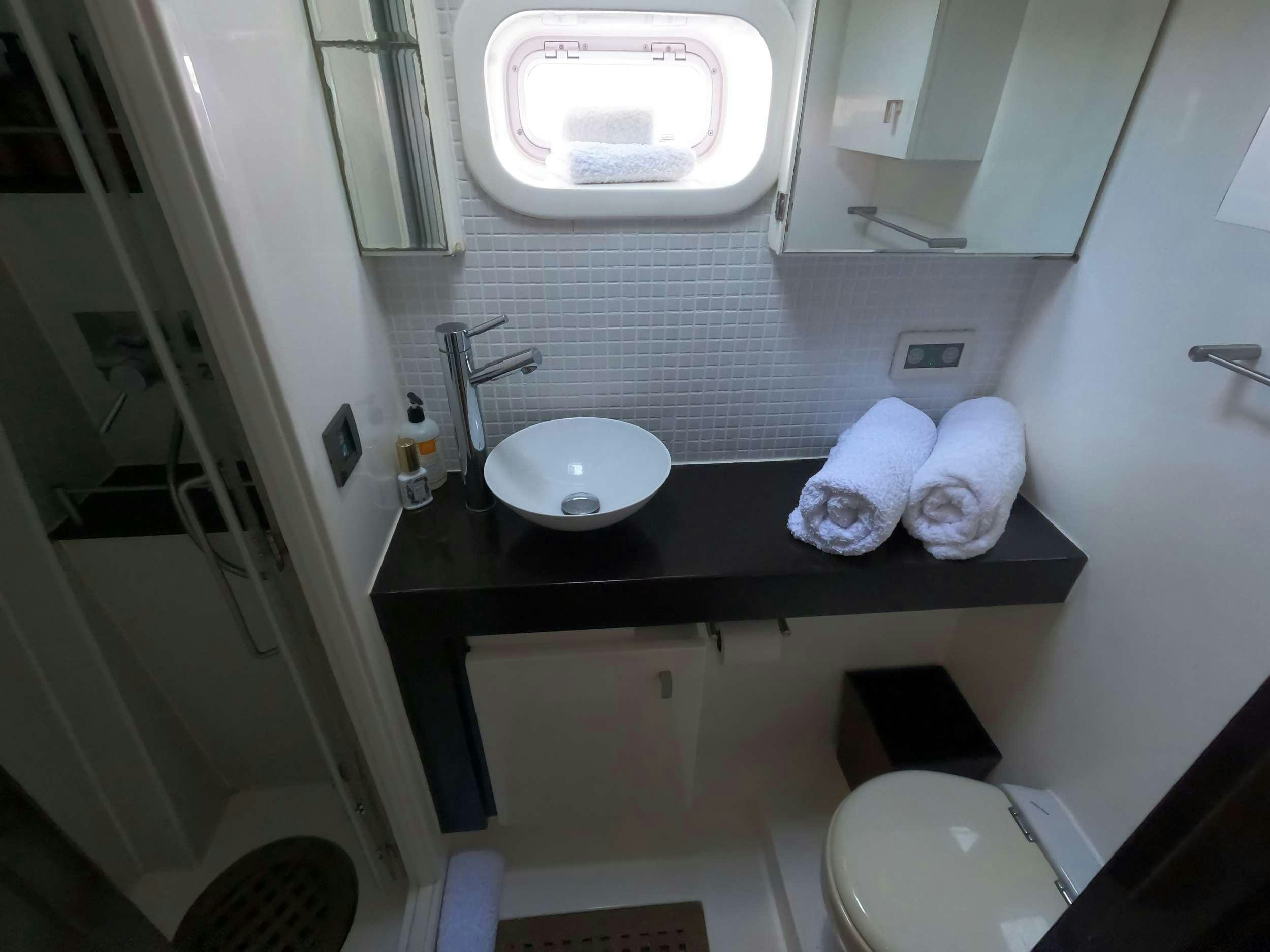 a bathroom with a sink and a mirror aboard SERENDIPITY Yacht for Charter