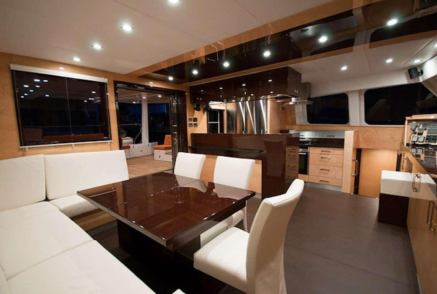 a large kitchen with a dining table aboard SERENDIPITY Yacht for Charter