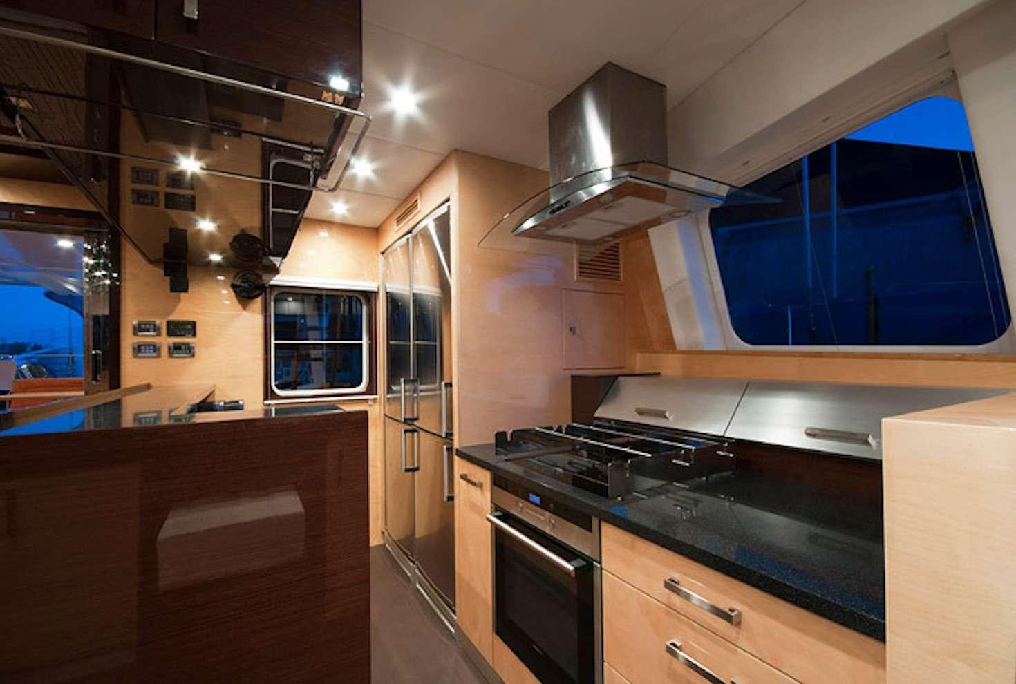 a kitchen with a stove and cabinets aboard SERENDIPITY Yacht for Charter