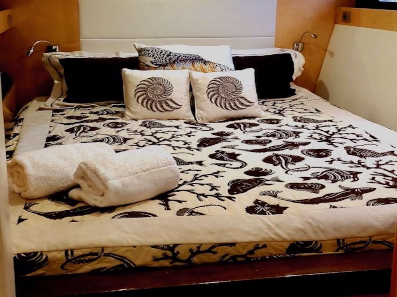 a bed with pillows aboard SERENDIPITY Yacht for Charter