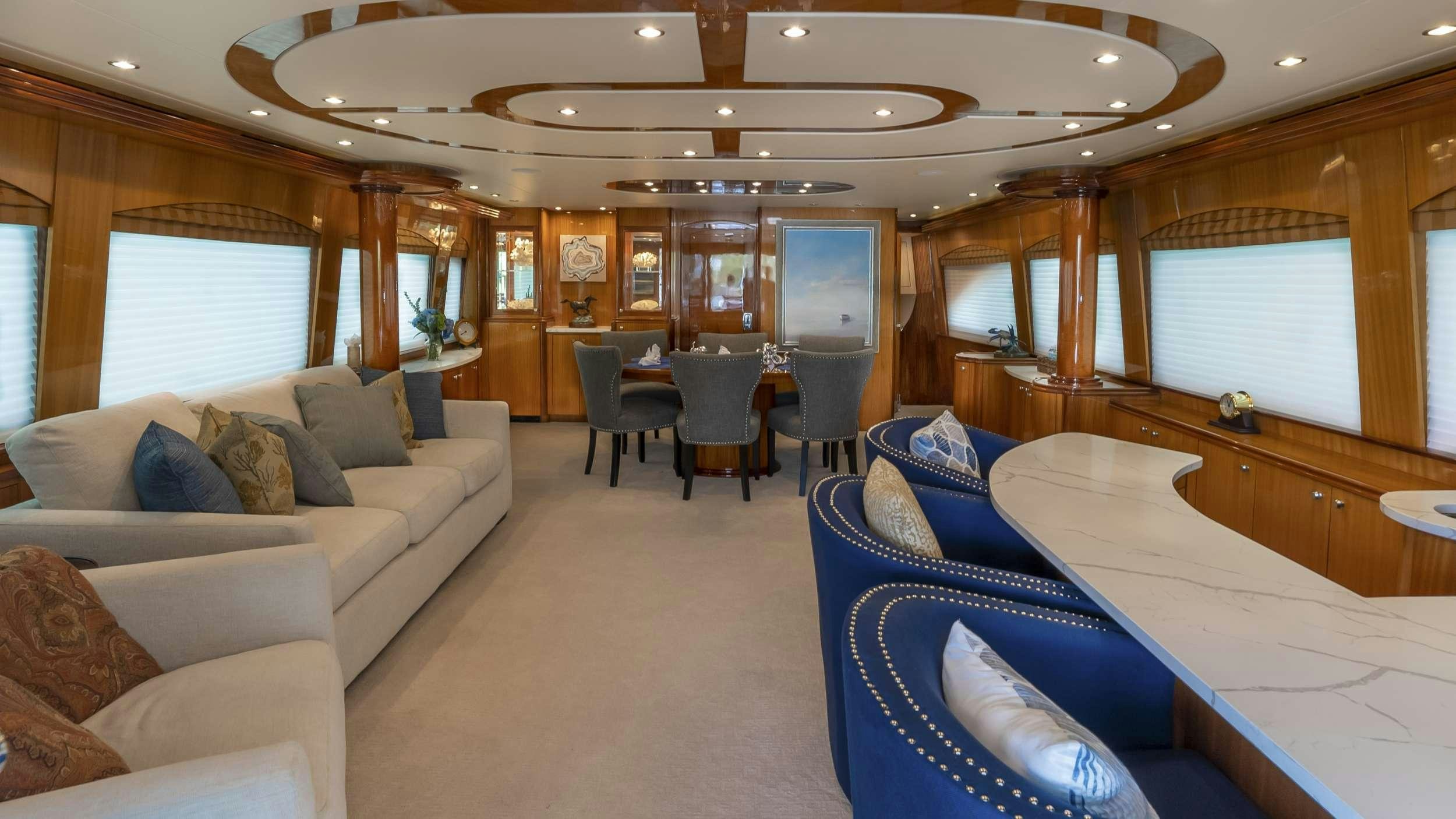 a large living room with a large bed and a large window aboard GALLOPIN Yacht for Charter
