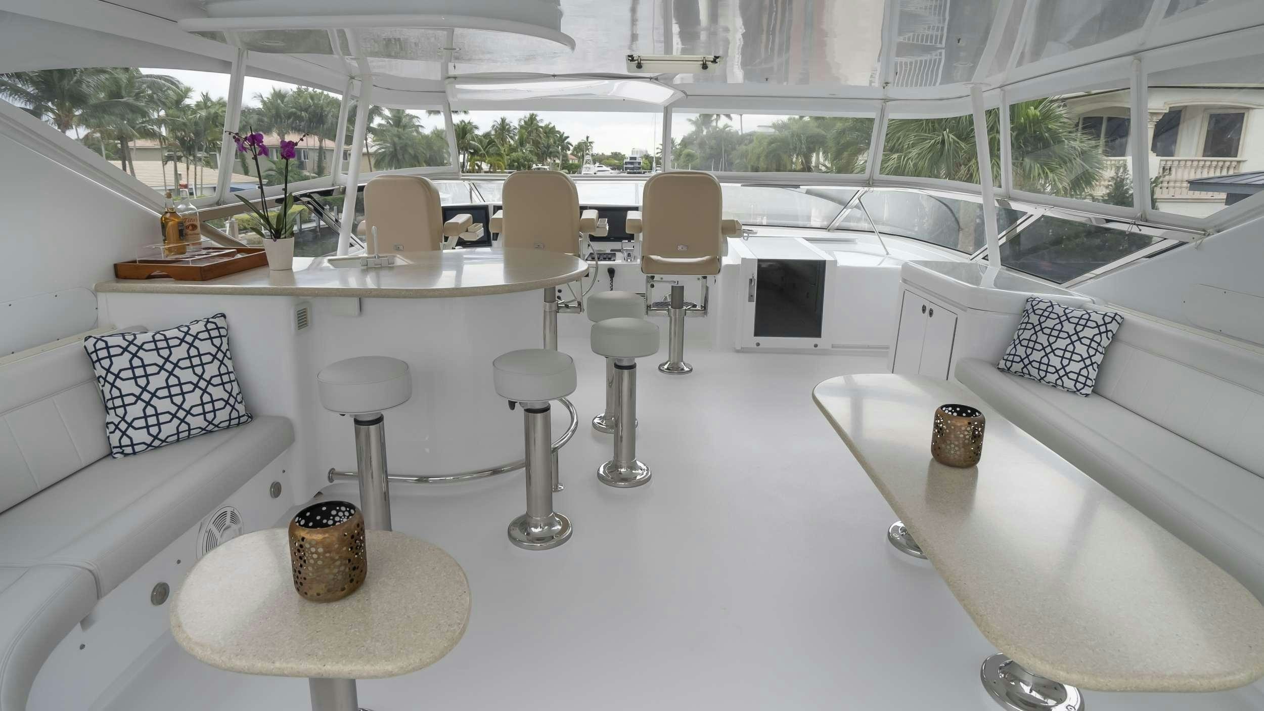 a room with a table chairs and a couch aboard GALLOPIN Yacht for Charter