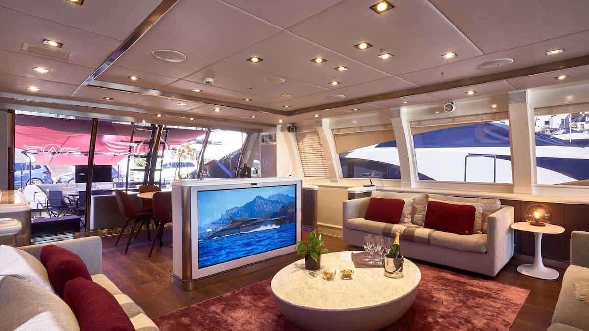 a living room with a large screen aboard SETTE Yacht for Charter