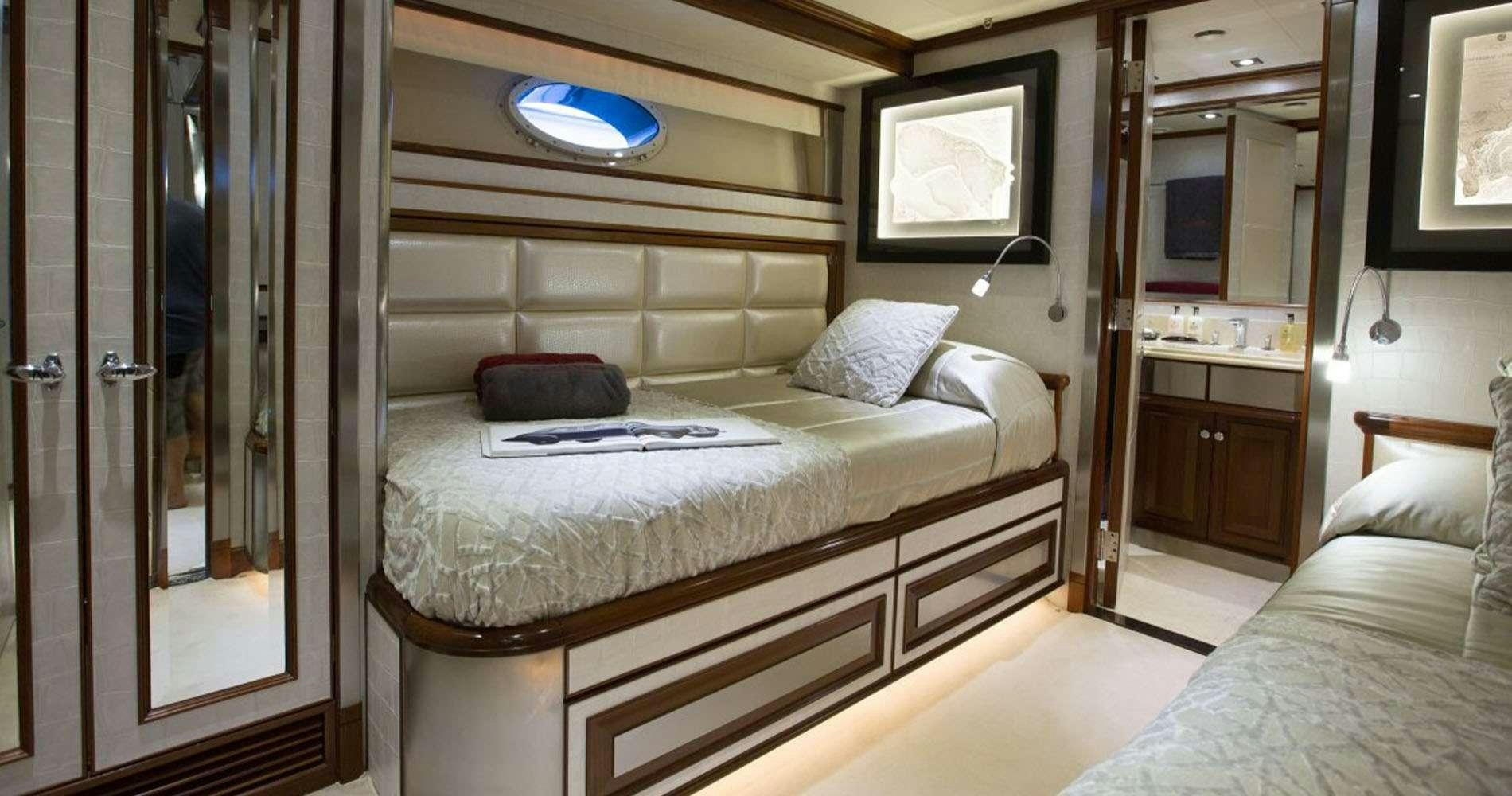 a room with a bed and a television aboard SETTE Yacht for Charter