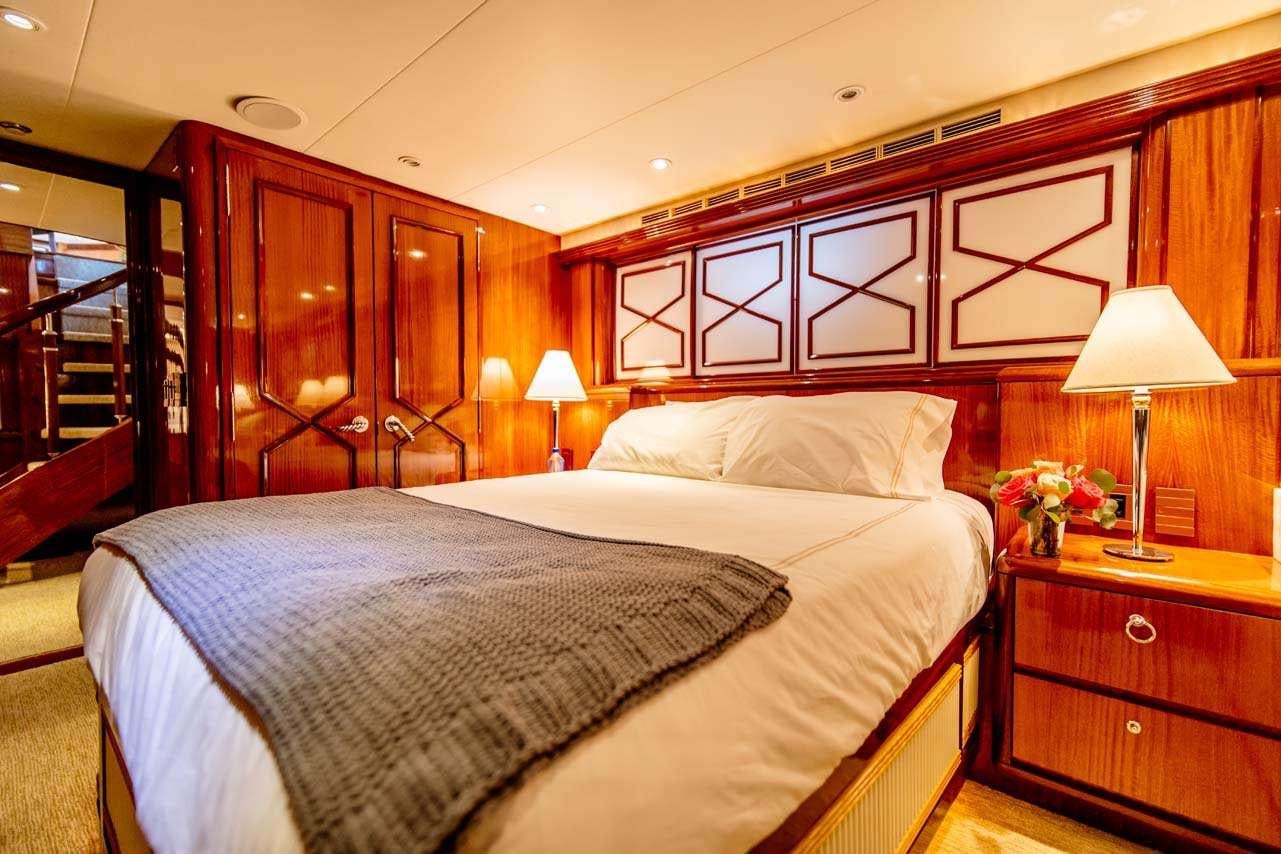 a bedroom with a bed and a desk aboard SUMMERTIME II Yacht for Charter