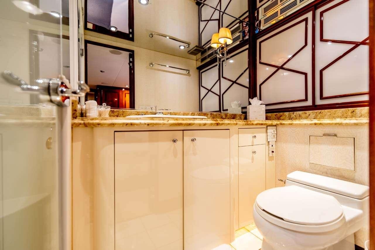 a bathroom with a toilet and cabinets aboard SUMMERTIME II Yacht for Charter