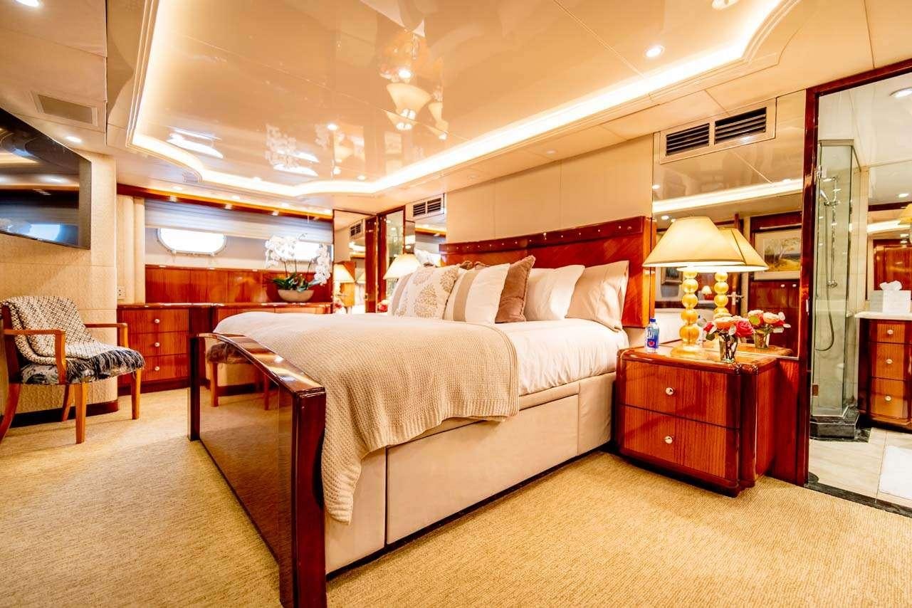 a bedroom with a bed and a desk aboard SUMMERTIME II Yacht for Charter