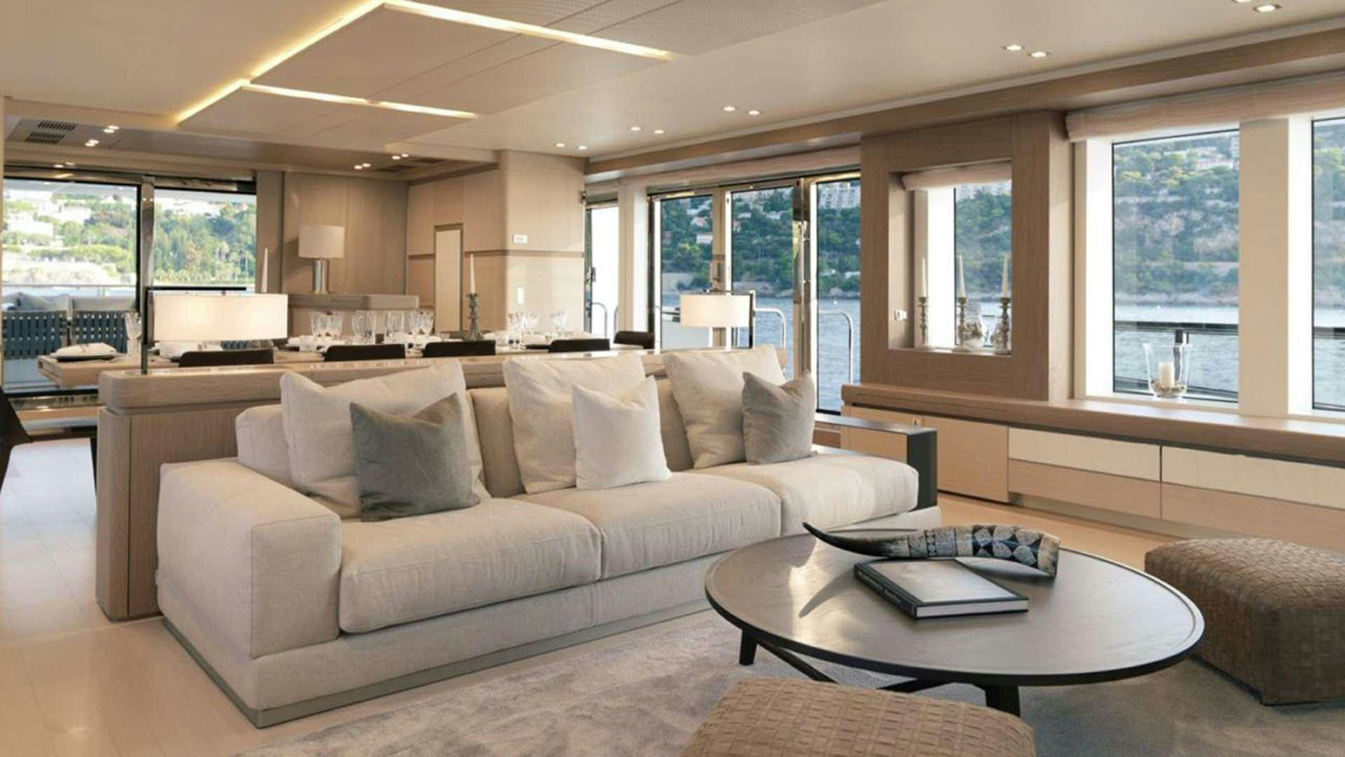 a living room with a couch and a coffee table aboard LEUDIN I Yacht for Charter