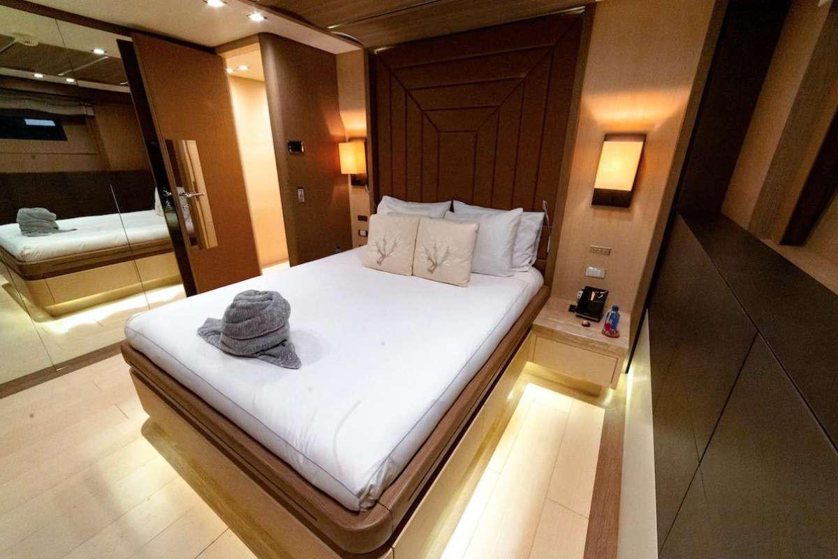 a hotel room with a large bed aboard LEUDIN I Yacht for Charter