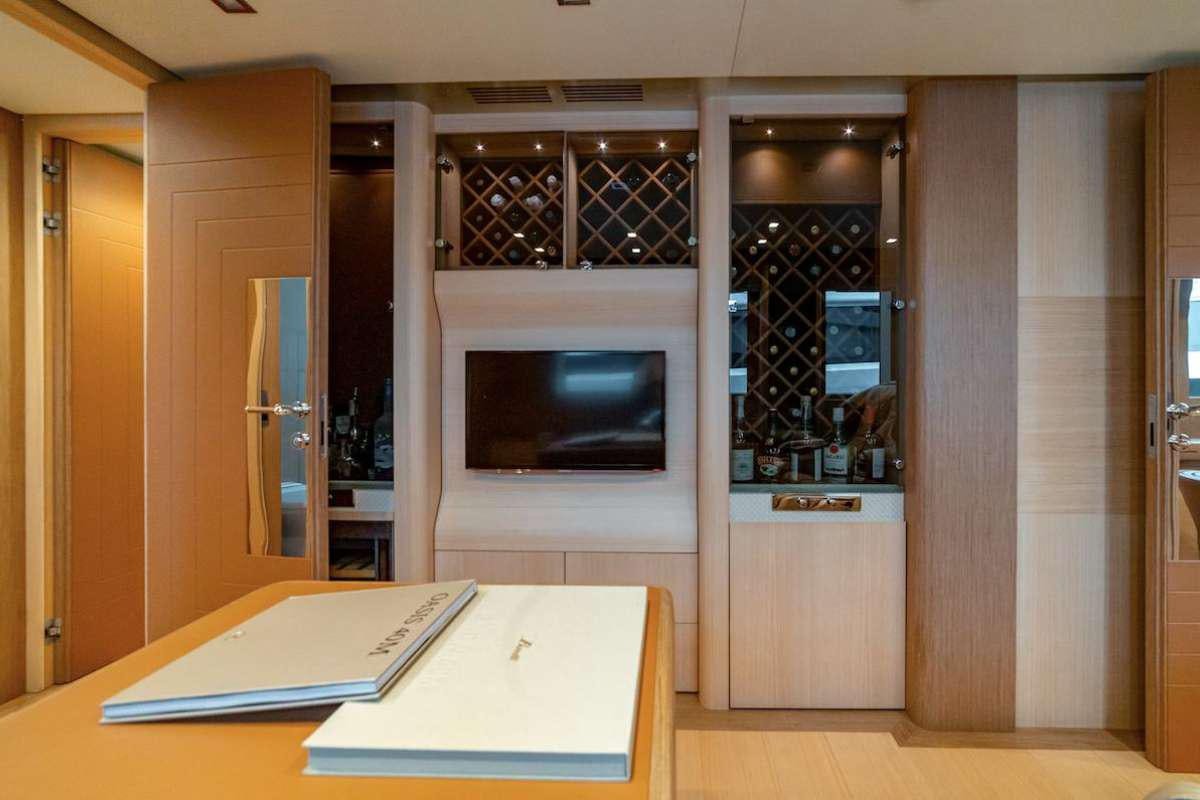 a room with a tv and a book on a table aboard LEUDIN I Yacht for Charter