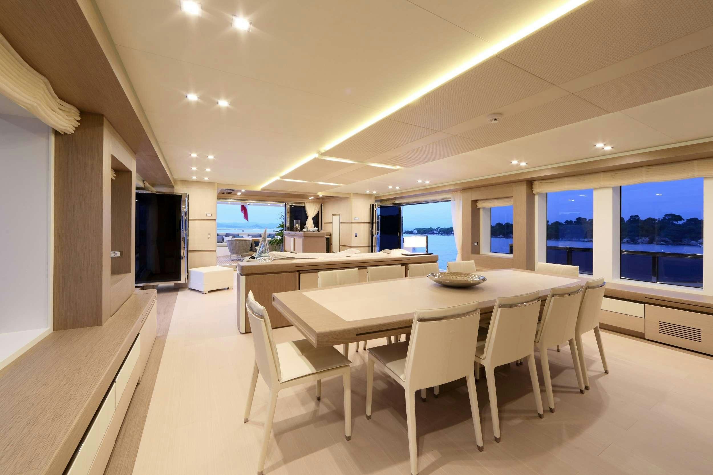 a large kitchen with a table and chairs aboard LEUDIN I Yacht for Charter