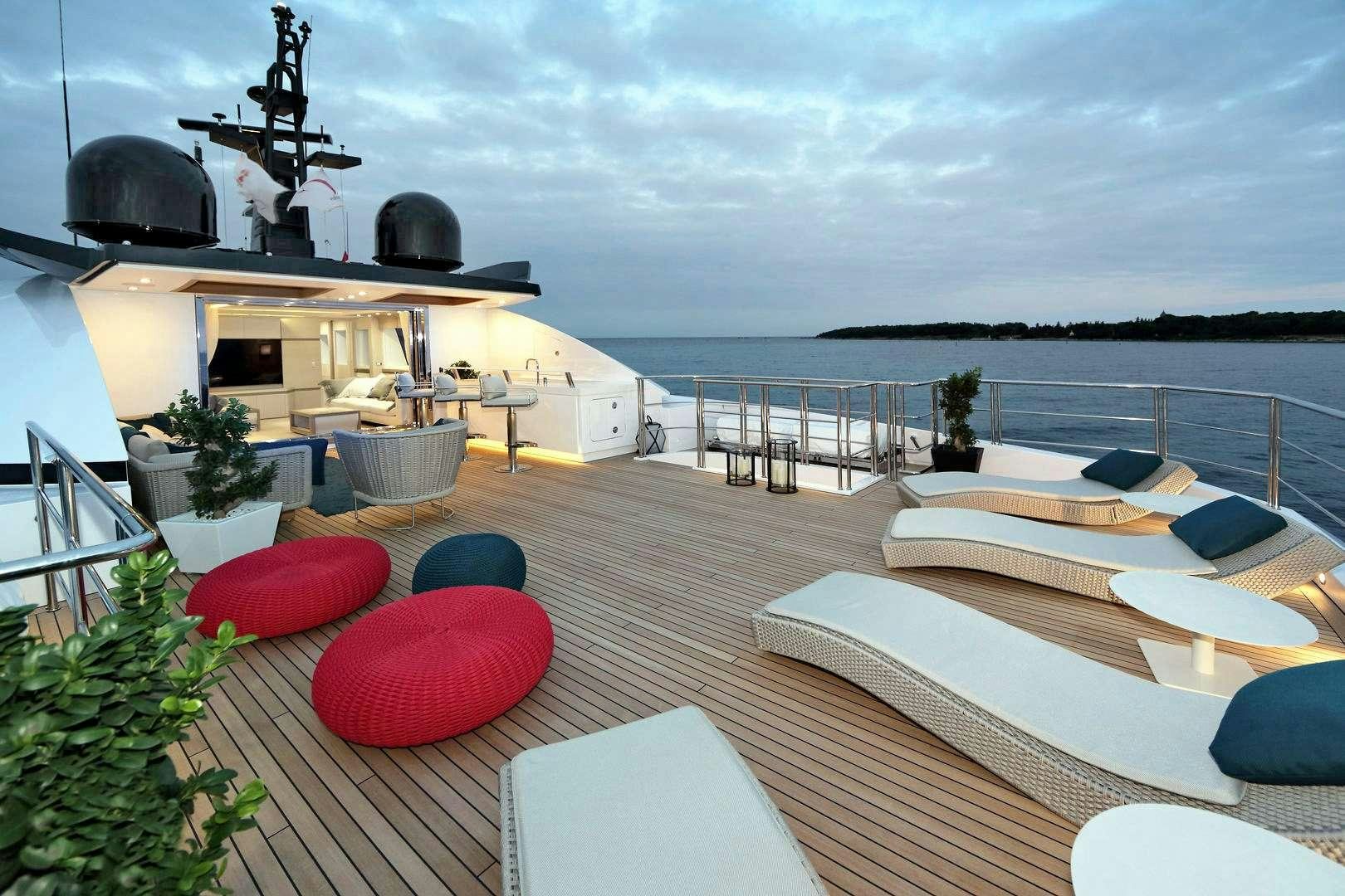 a deck with a pool and a large building with a slide aboard LEUDIN I Yacht for Charter