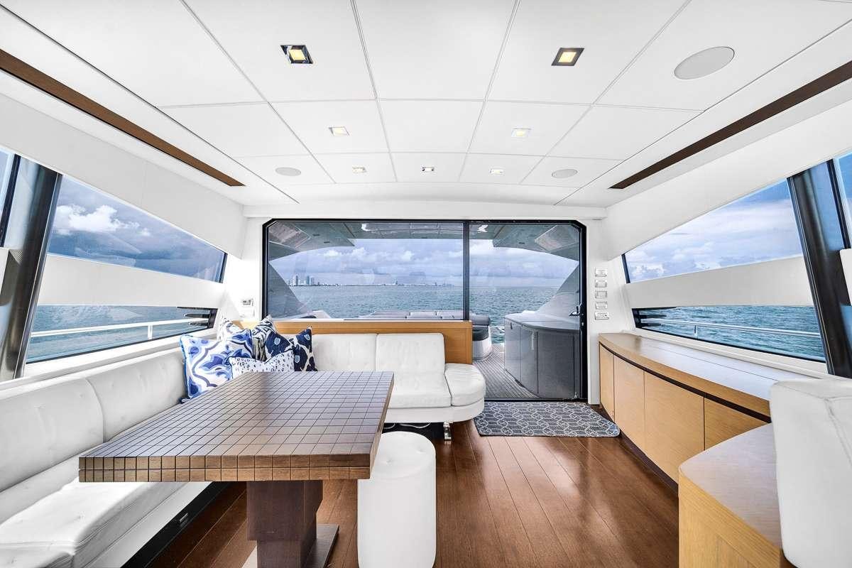 a room with a table and chairs aboard VANTAGE Yacht for Charter