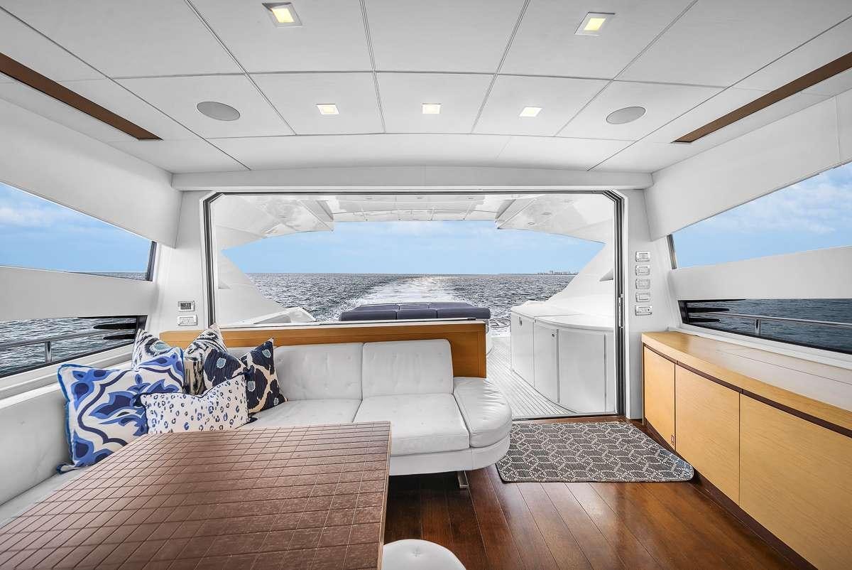a room with a table and couches aboard VANTAGE Yacht for Charter
