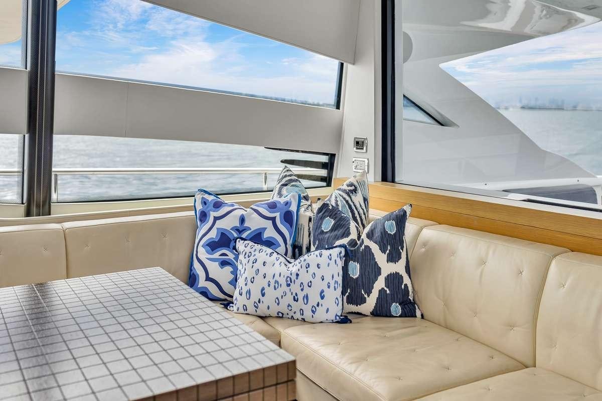 a couch with pillows on it aboard VANTAGE Yacht for Charter