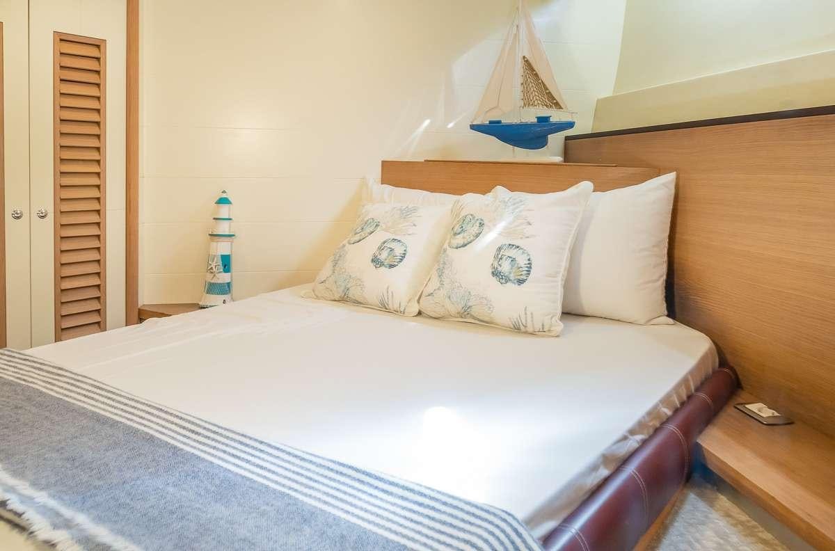 a bed with pillows aboard DIVA Yacht for Charter