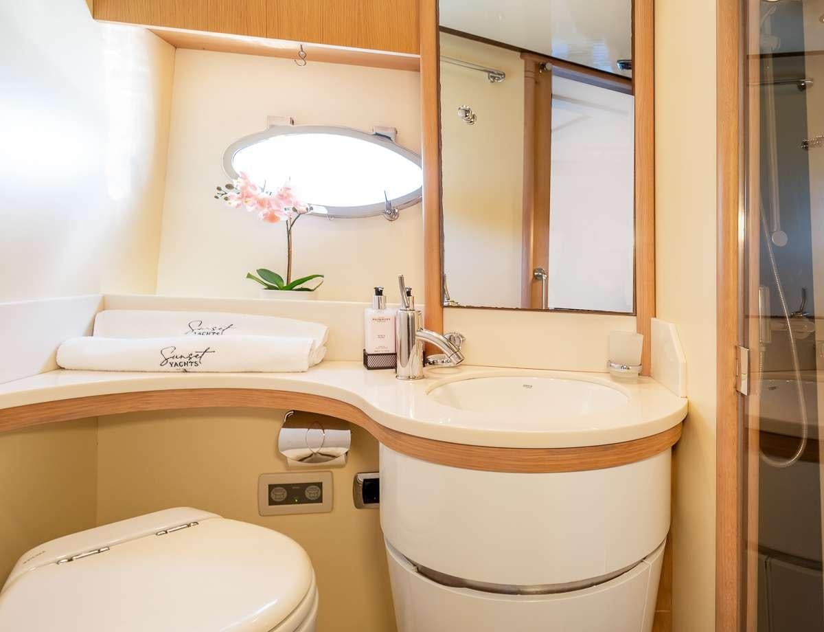 a bathroom with a large mirror aboard DIVA Yacht for Charter