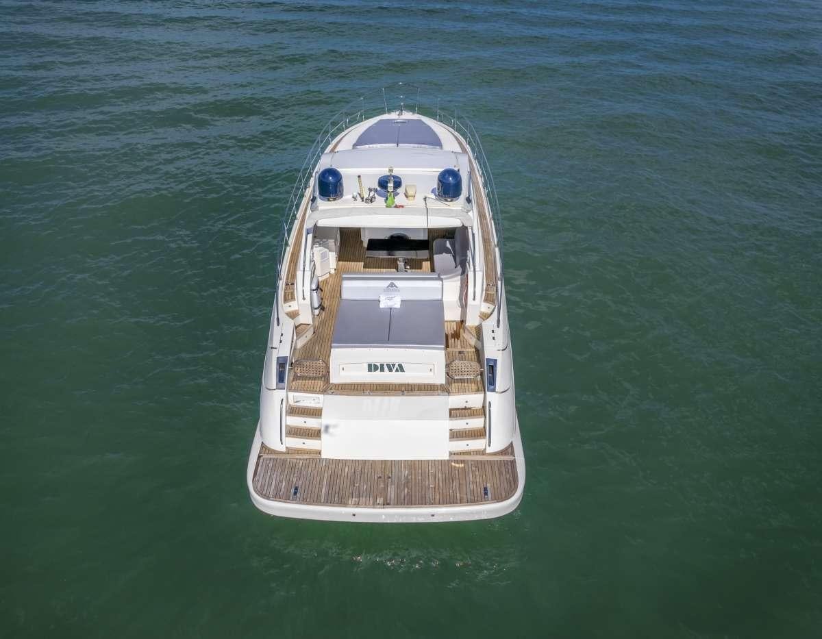 a small white boat in the water aboard DIVA Yacht for Charter