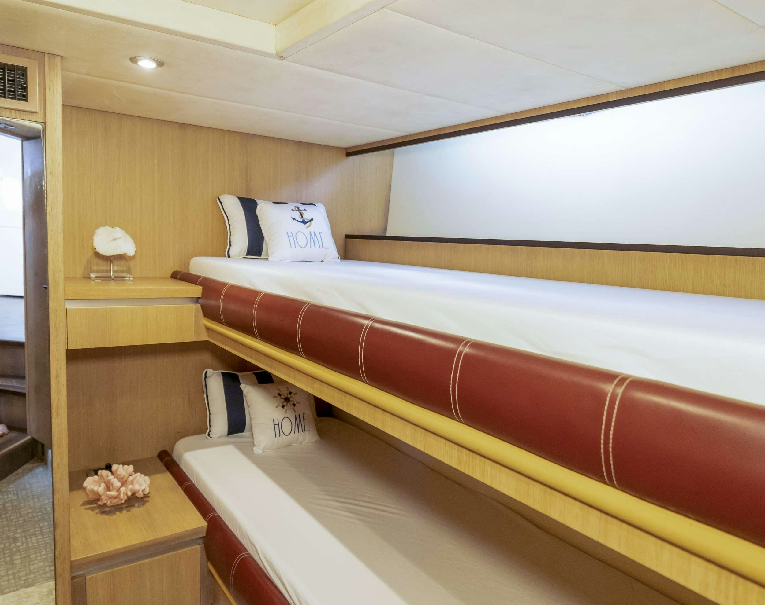 a room with a bed and a desk aboard DIVA Yacht for Charter