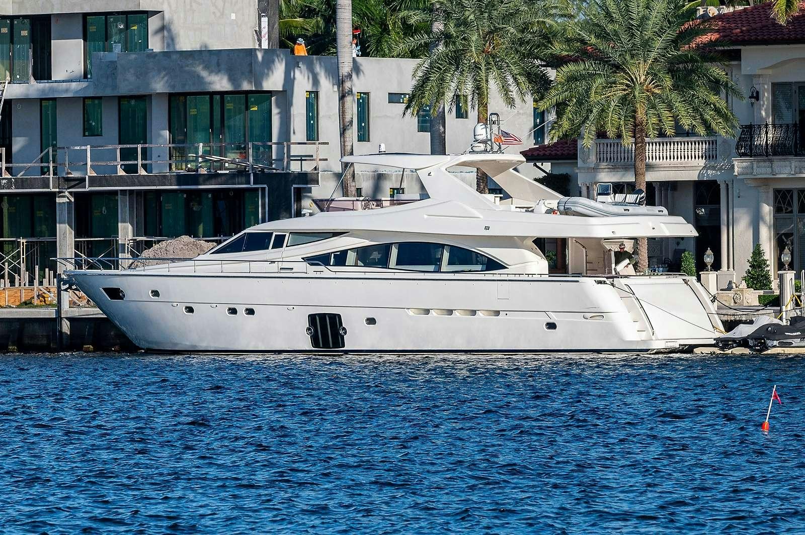 a white boat in a body of water aboard THE LIFE  Yacht for Charter