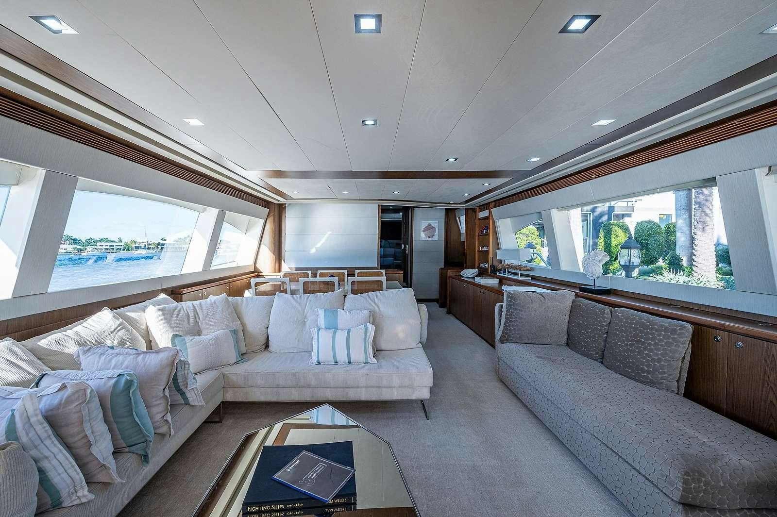 a large living room with a large window aboard THE LIFE  Yacht for Charter