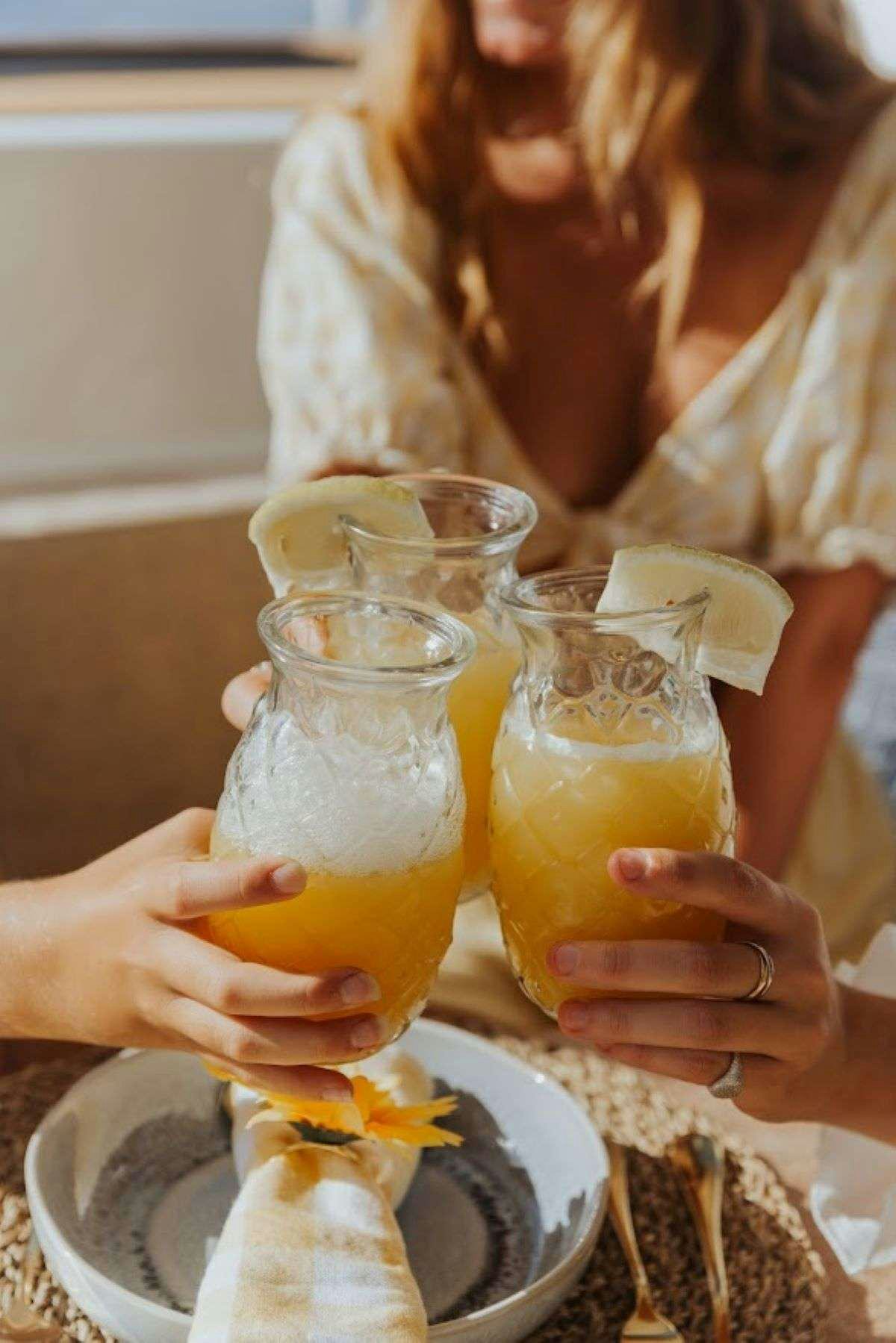 a woman pouring a drink into a glass aboard Purely Blu Yacht for Charter