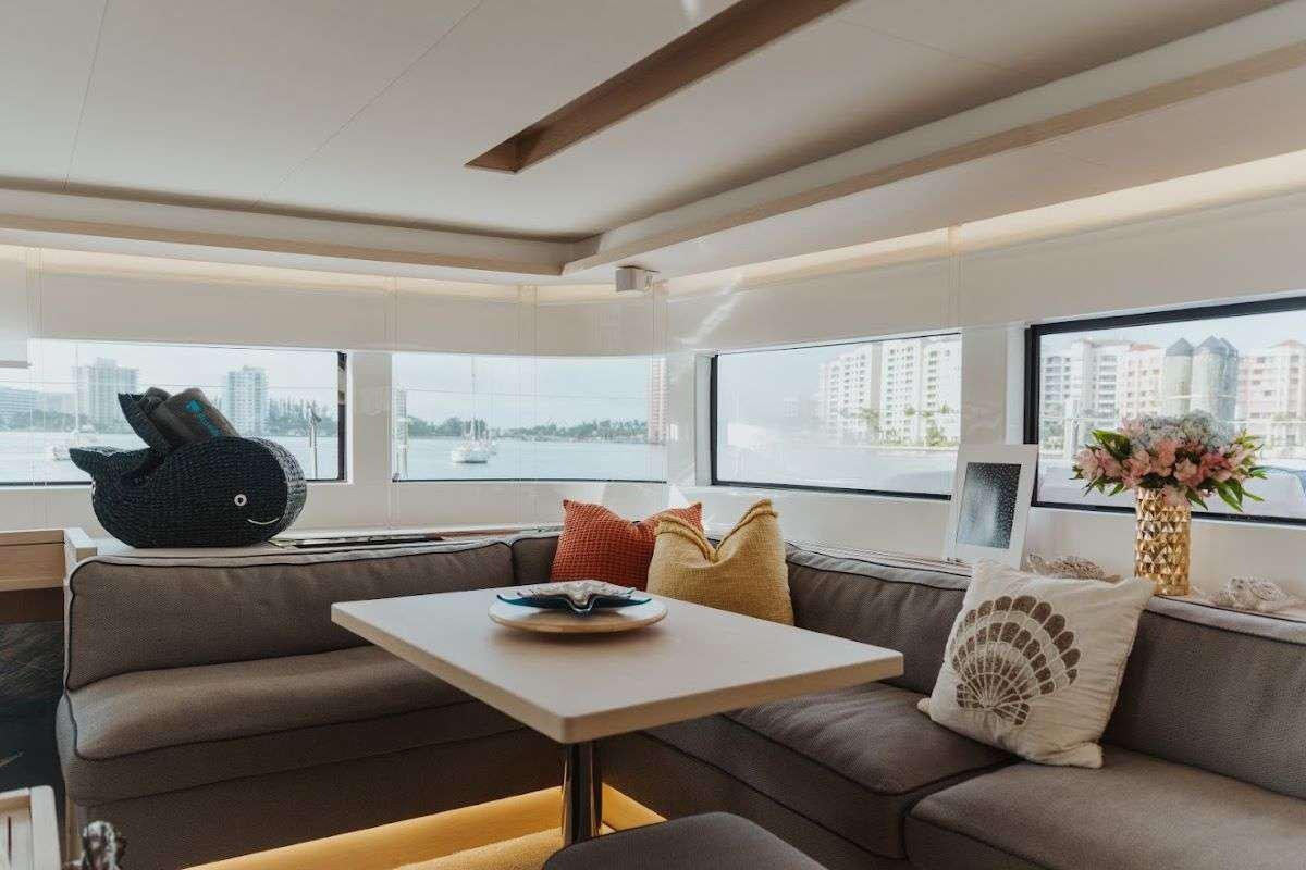 a living room with a couch and a coffee table aboard Purely Blu Yacht for Charter