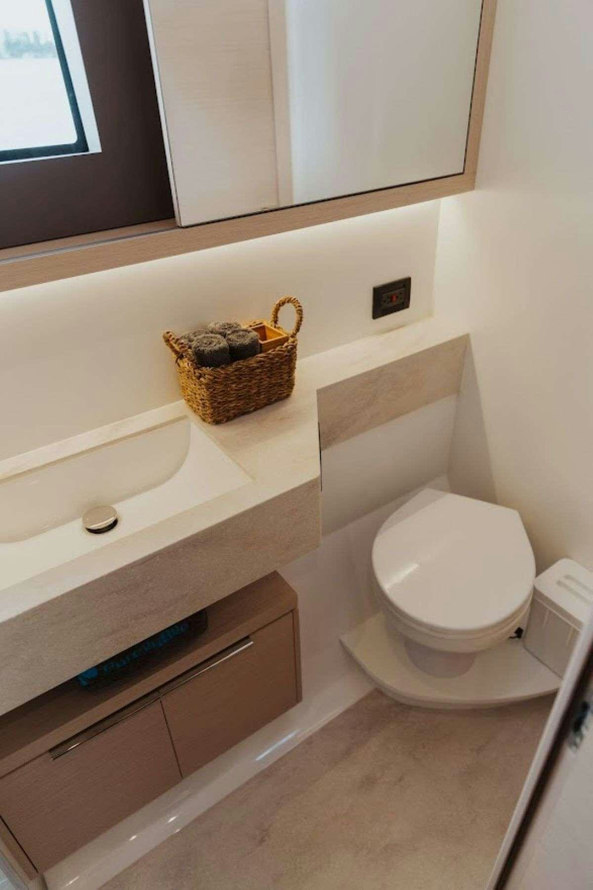 a basket sits on top of a toilet aboard Purely Blu Yacht for Charter