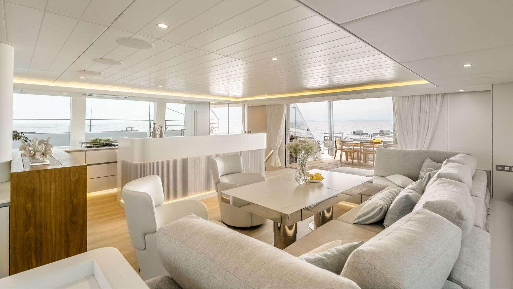 a living room with a large window aboard OHANA Yacht for Charter