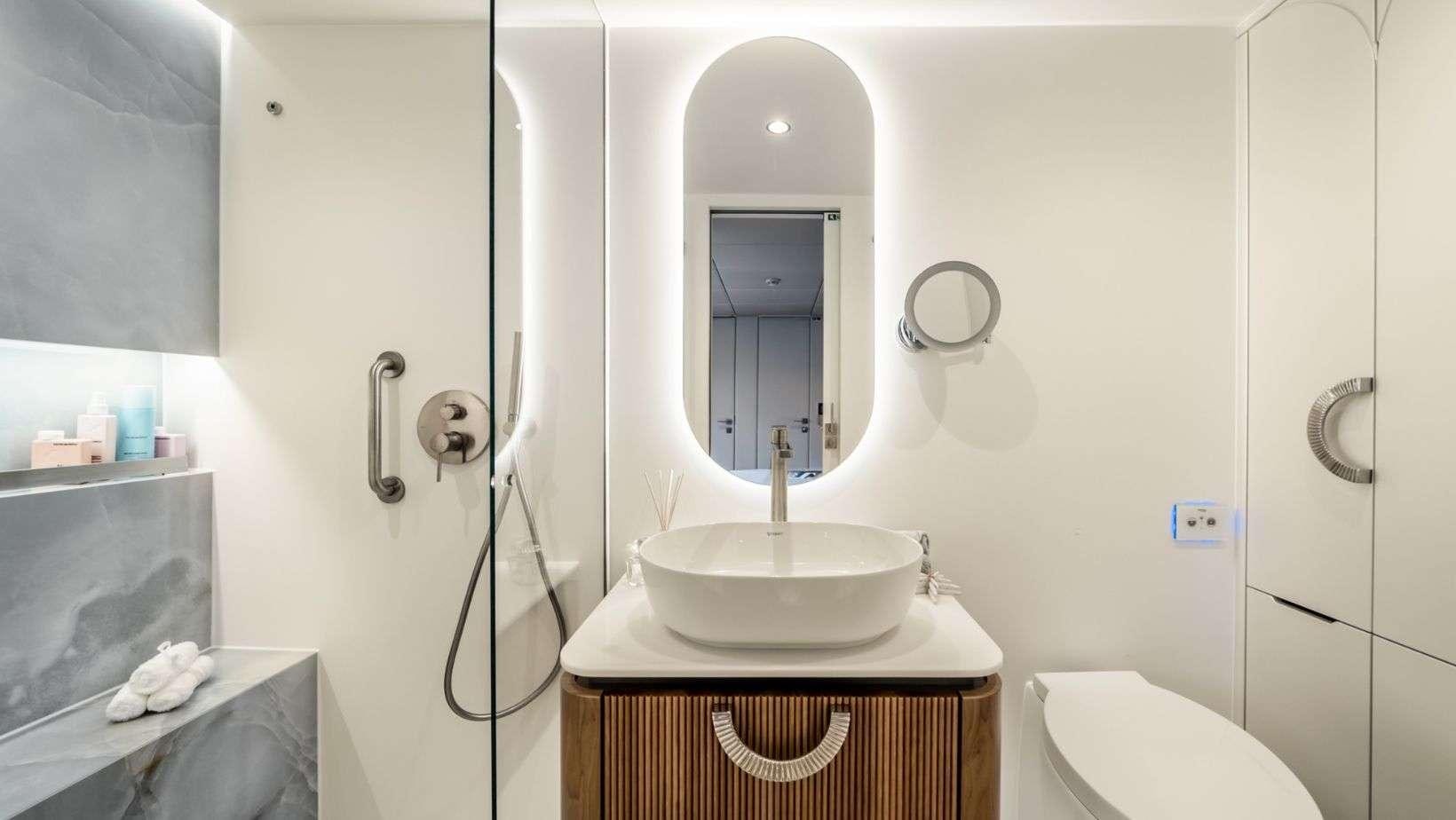 a bathroom with a sink and mirror aboard OHANA Yacht for Charter
