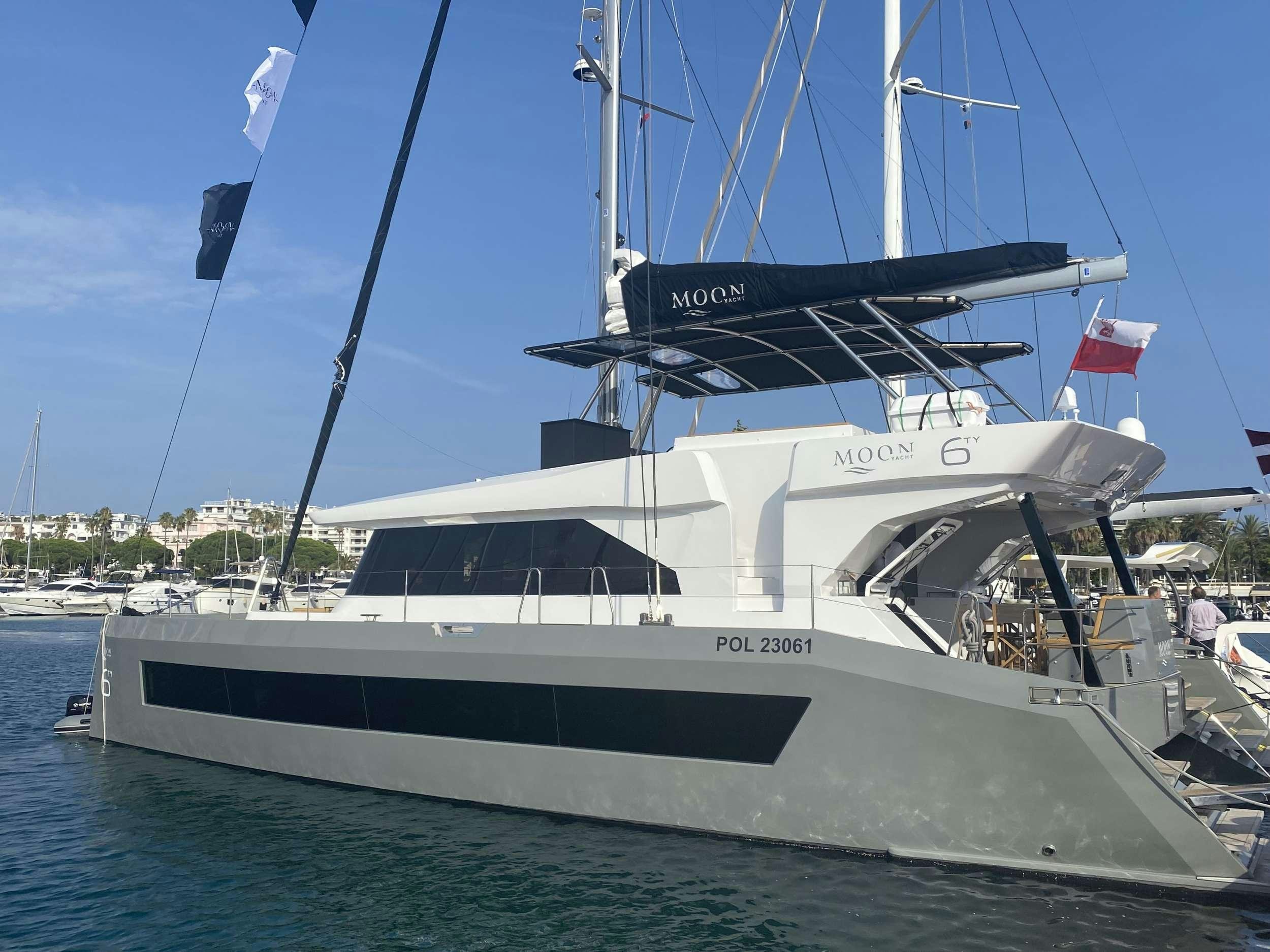 a white boat in the water aboard MOON DRAGON Yacht for Charter