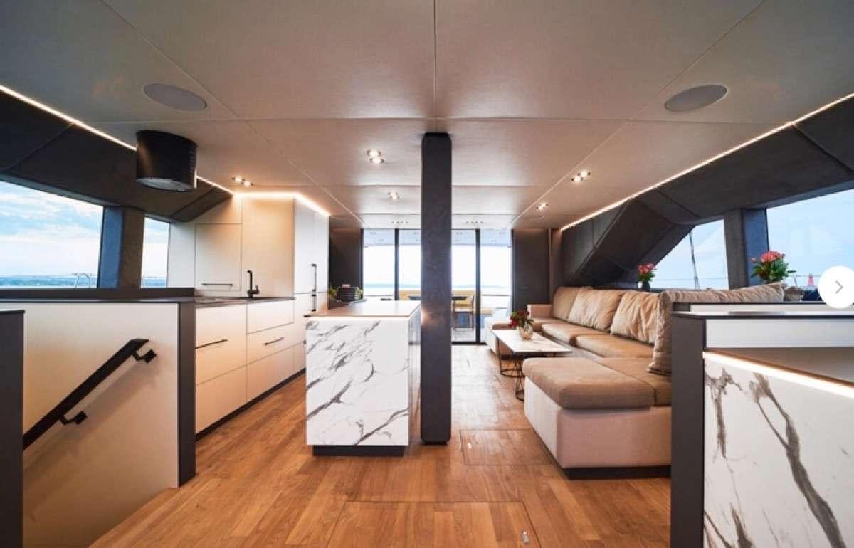 a living room with a large window aboard MOON DRAGON Yacht for Charter