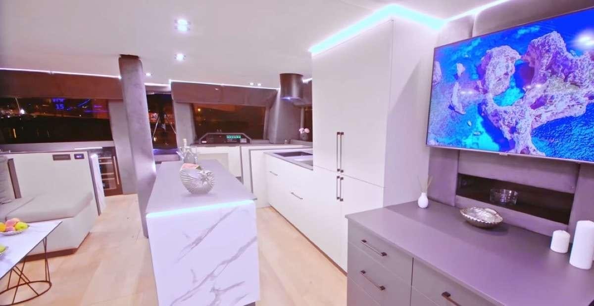 a kitchen with a large painting aboard MOON DRAGON Yacht for Charter